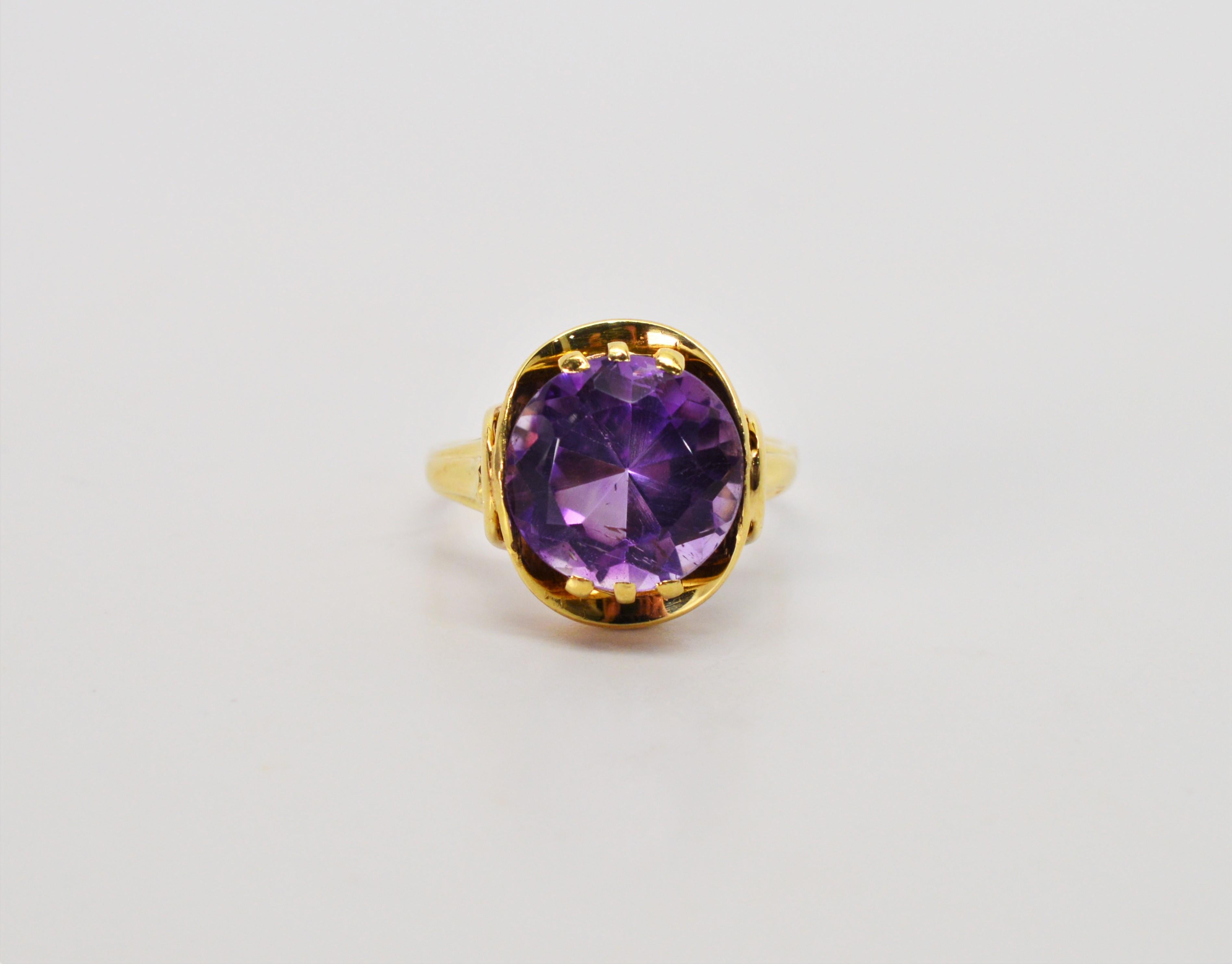 Glamorous, in a rich royal purple, this round fantasy cut five carat amethyst boldly sits center on this fourteen karat yellow gold ring. In size 8.5.
This ring can be resized by your jeweler. In gift box.   