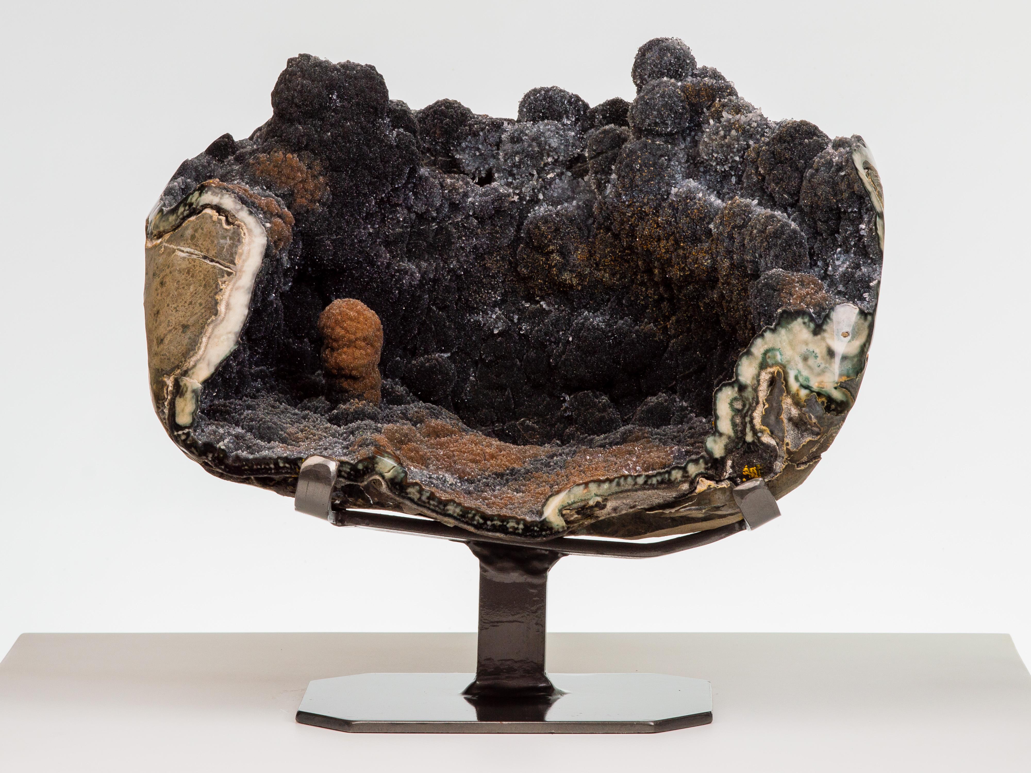 An exceptional formation resembling an other-worldly landscape. This spherical
geode has been exposed to reveal a gorgeous amethystine quartz interior, the
tinted stalactites resembling mountains and terrain, with cloud-like sparkling
druze