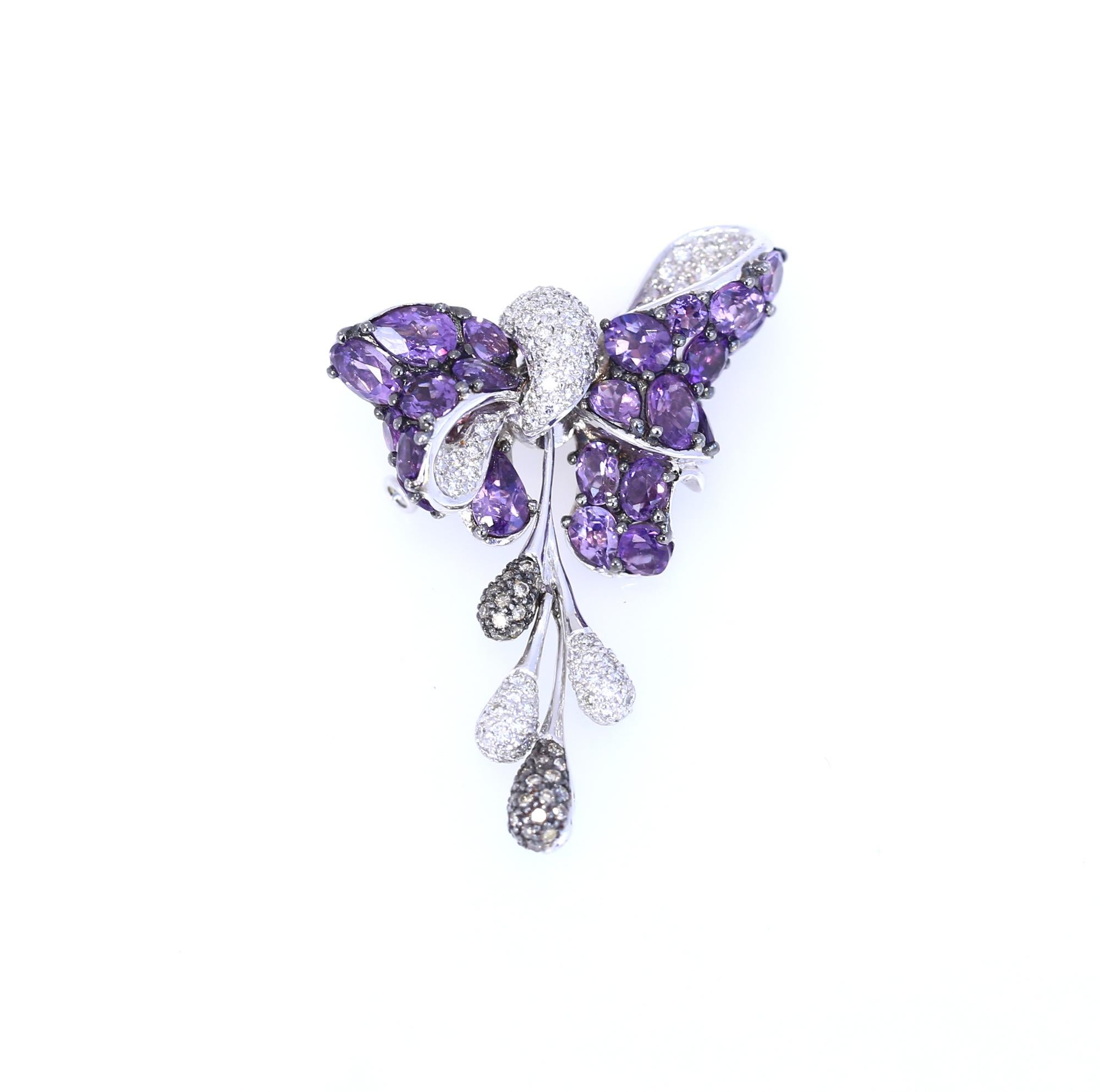 Bow Brooch with Amethyst white and fancy Diamonds on 18K White Gold.
Organic design elements. Elegant bow consisting of fine Amethysts. 
Contemporary fine work of the jeweler. The Amethysts set amazingly! 
Fine item a real marvel of modern jewelry