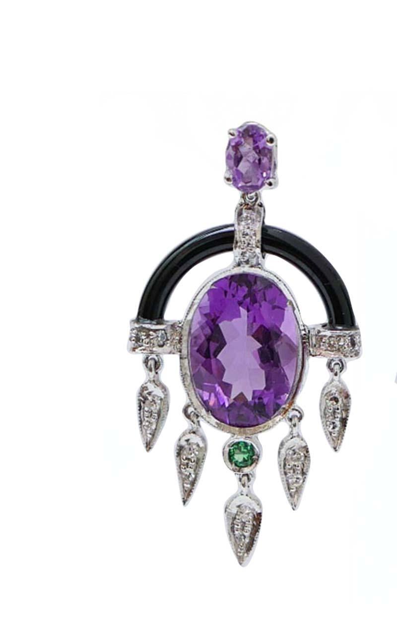 Fantastic dangle earrings in platinum structure mounted with an amethyst in the upper part; in the middle, a central amethyst surrounded by structures studded with diamonds and, below, an onyx. As pendant, leaves studded with diamonds and a
