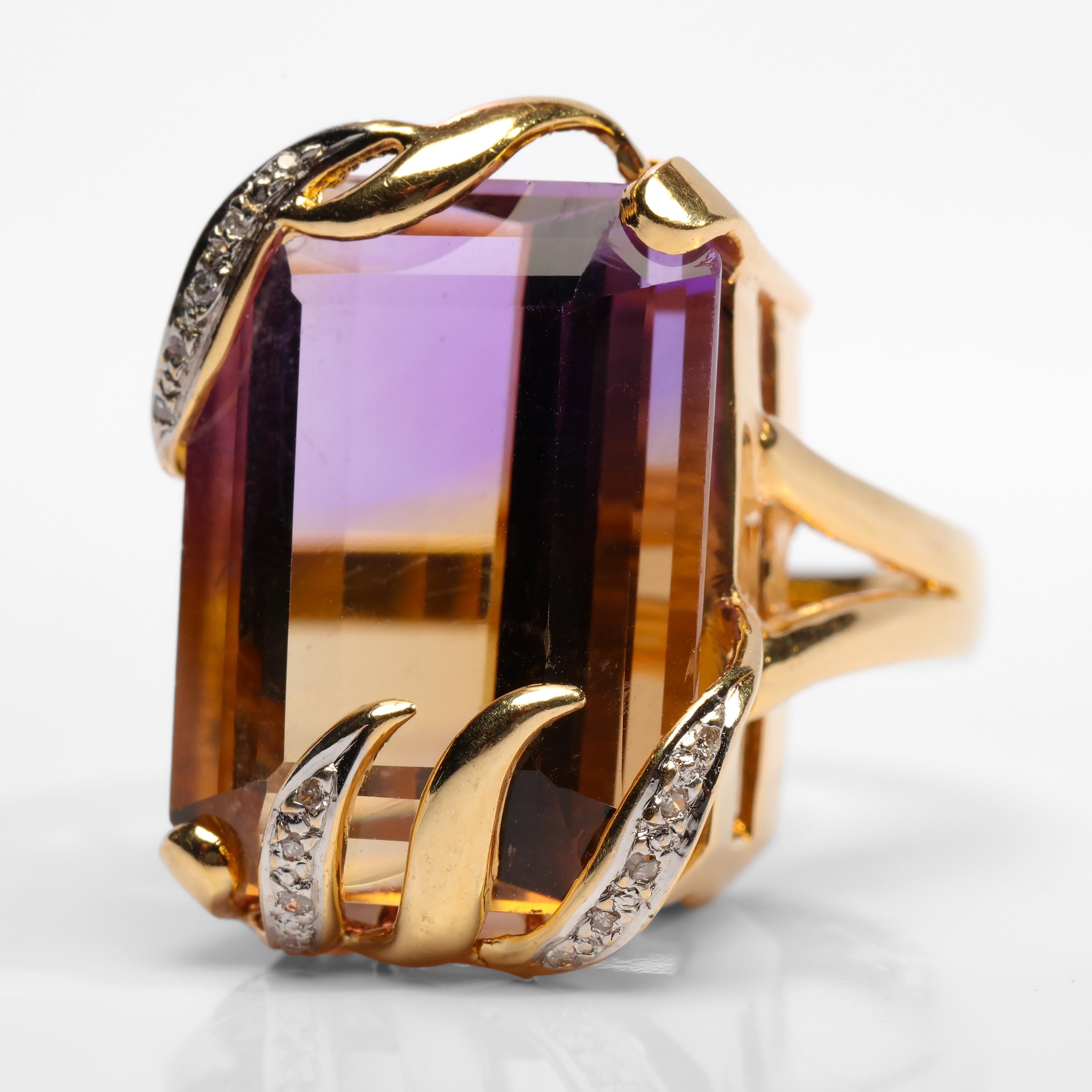 This exuberant, stylish and unique ring from the Midcentury features a sizeable emerald-cut ametrine gem. Ametrine is a naturally-occurring blend of citrine and ametrine that is the result of temperature changes that occur when the gemstone is