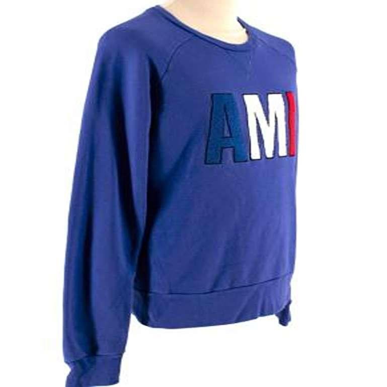 Ami Blue Logo Sweatshirt 

- Crewneck
- Loopback fleece
- Patched Ami letters on chest in blue, white and red
- Long sleeved
- Classic Fit

Materials:
- 80% Cotton
- 20% Polyester 

Machine Washable 

Made in Portugal 

PLEASE NOTE, THESE ITEMS ARE