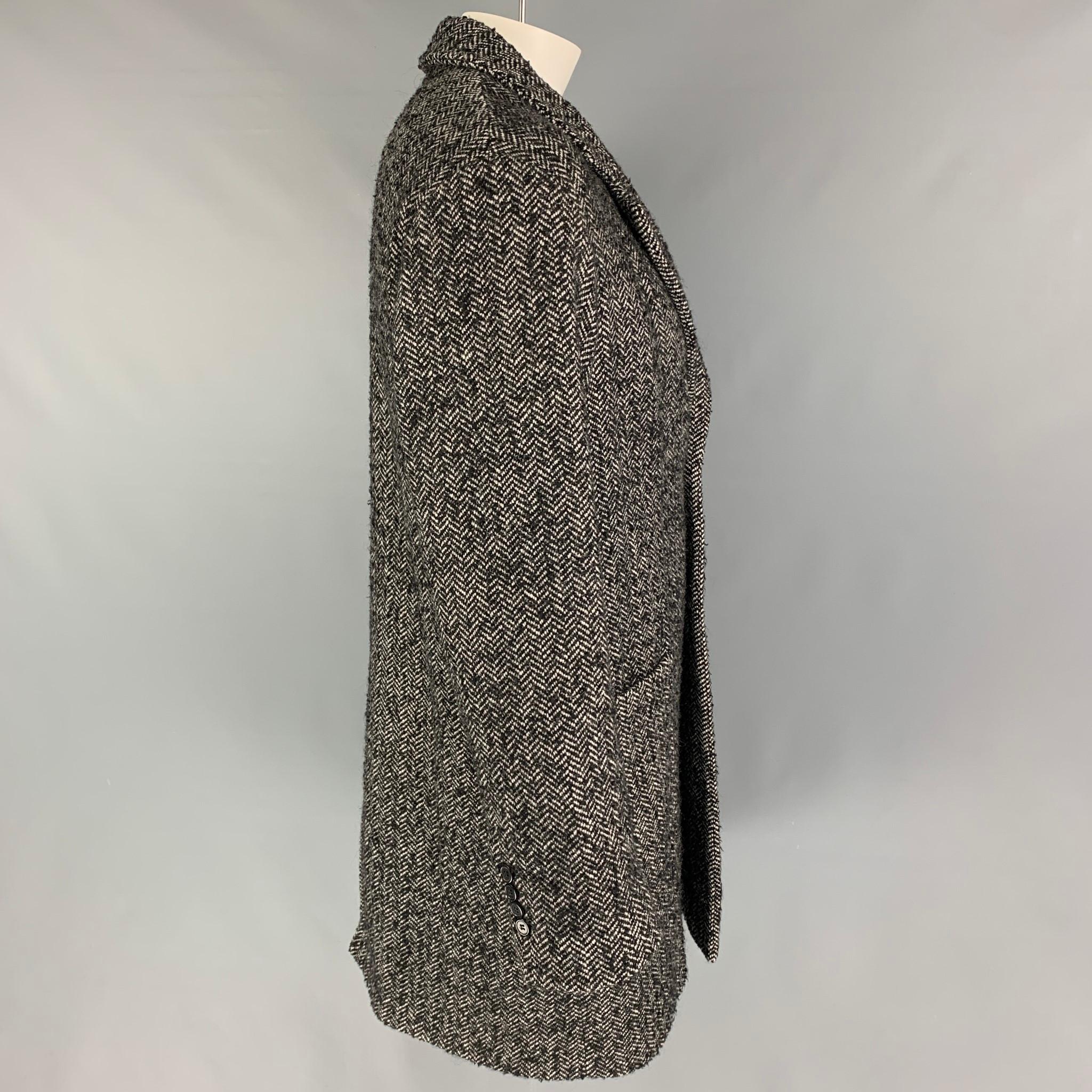 AMI by ALEXANDRE MATIUSSI coat comes in a black & white herringbone wool blend with a full liner featuring a notch lapel, loose fit, patch pockets, single back vent, and a buttoned closure.

Very Good Pre-Owned Condition.
Marked: