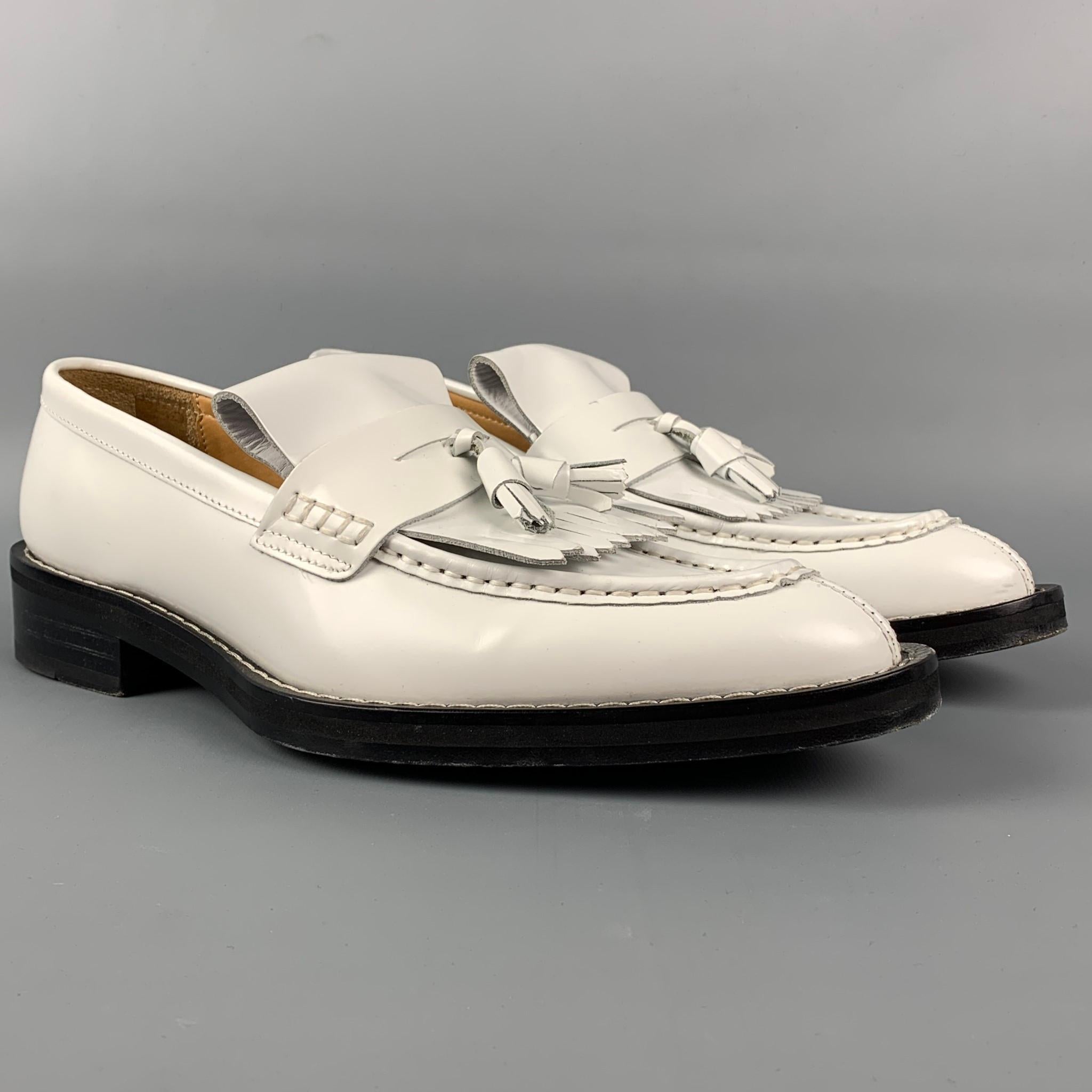 AMI by ALEXANDRE MATTIUSSI loafers comes in a white leather featuring a tassel design, fringe trim, almond moc toe, and a stacked leather heel. Includes box. Made in Portugal.

Very Good Pre-Owned Condition.
Marked: 42 / H19S101 901

Outsole: 12.5
