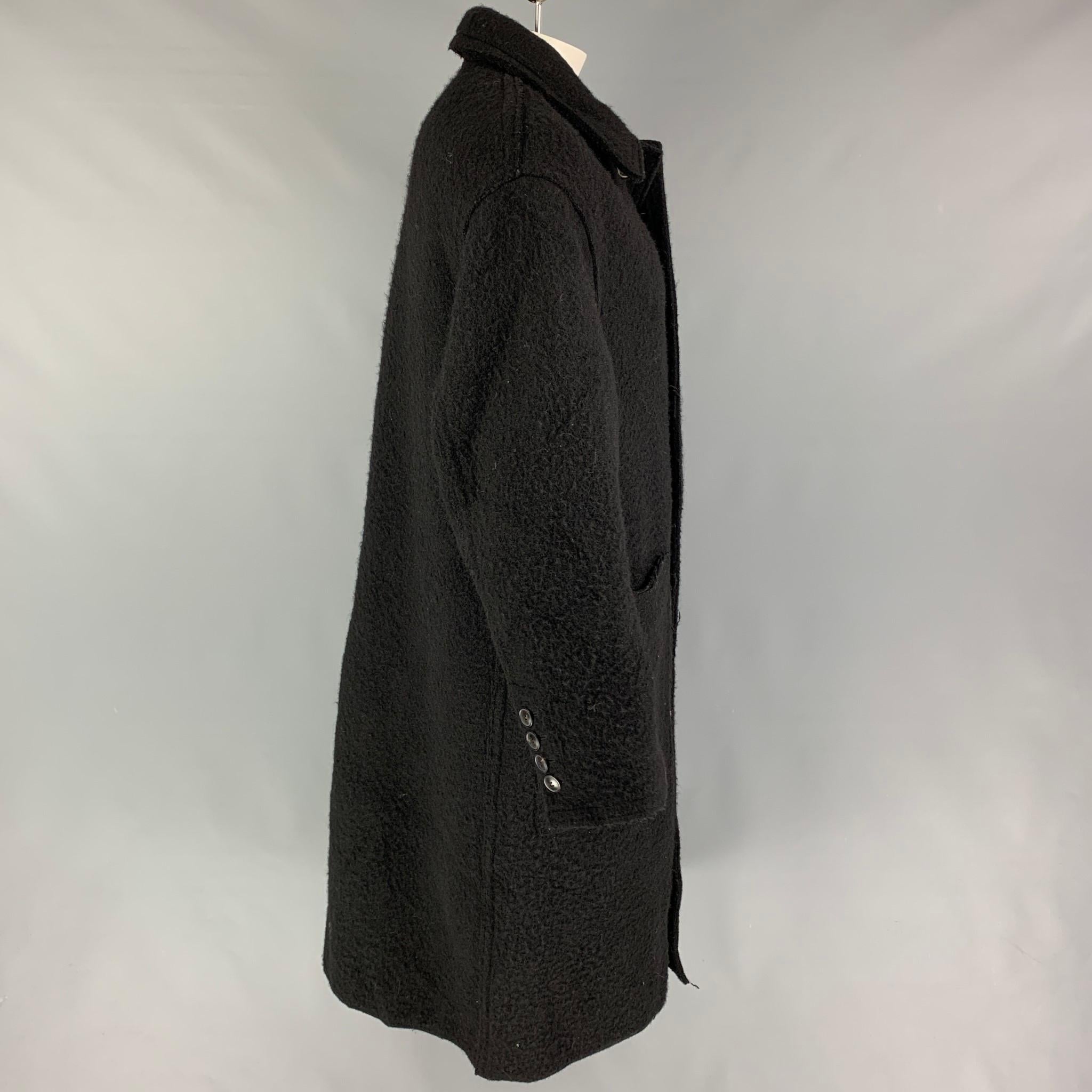 AMI by ALEXANDRE MATIUSSI coat comes in a black textured wool featuring a spread collar, patch pockets, single back vent, and a buttoned closure.

Very Good Pre-Owned Condition.
Marked: M

Measurements:

Shoulder: 23 in.
Chest: 48 in.
Sleeve: 24.5