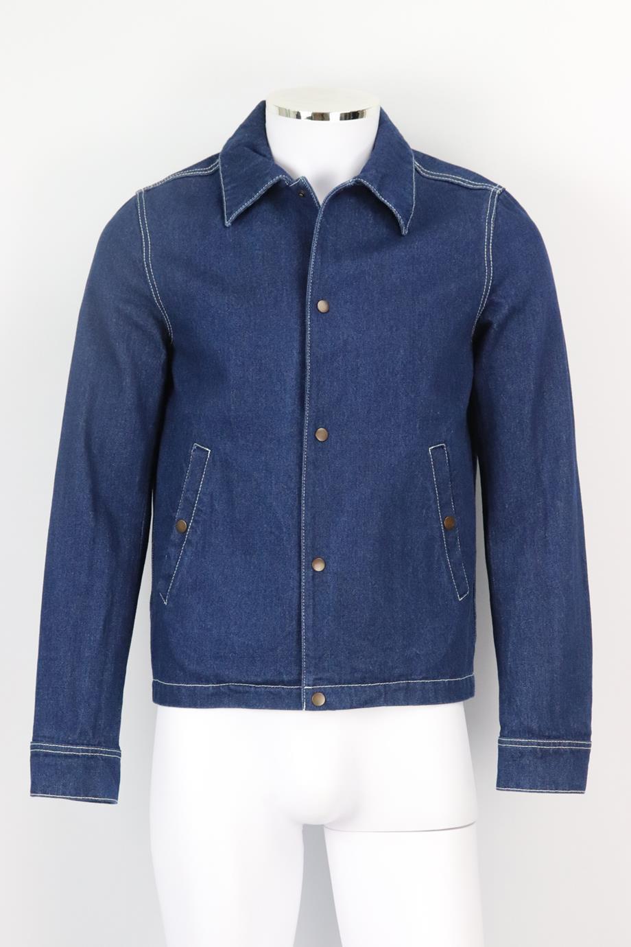 AMI Paris men's denim jacket. Blue. Long sleeve, crewneck. Button fastening at front. 100% Cotton. Size: XSmall (IT 44, EU 44, UK/US Chest 34). Shoulder to shoulder: 16 in. Bust: 40 in. Waist: 39 in. Hips: 37 in. Length: 25 in. Very good condition -