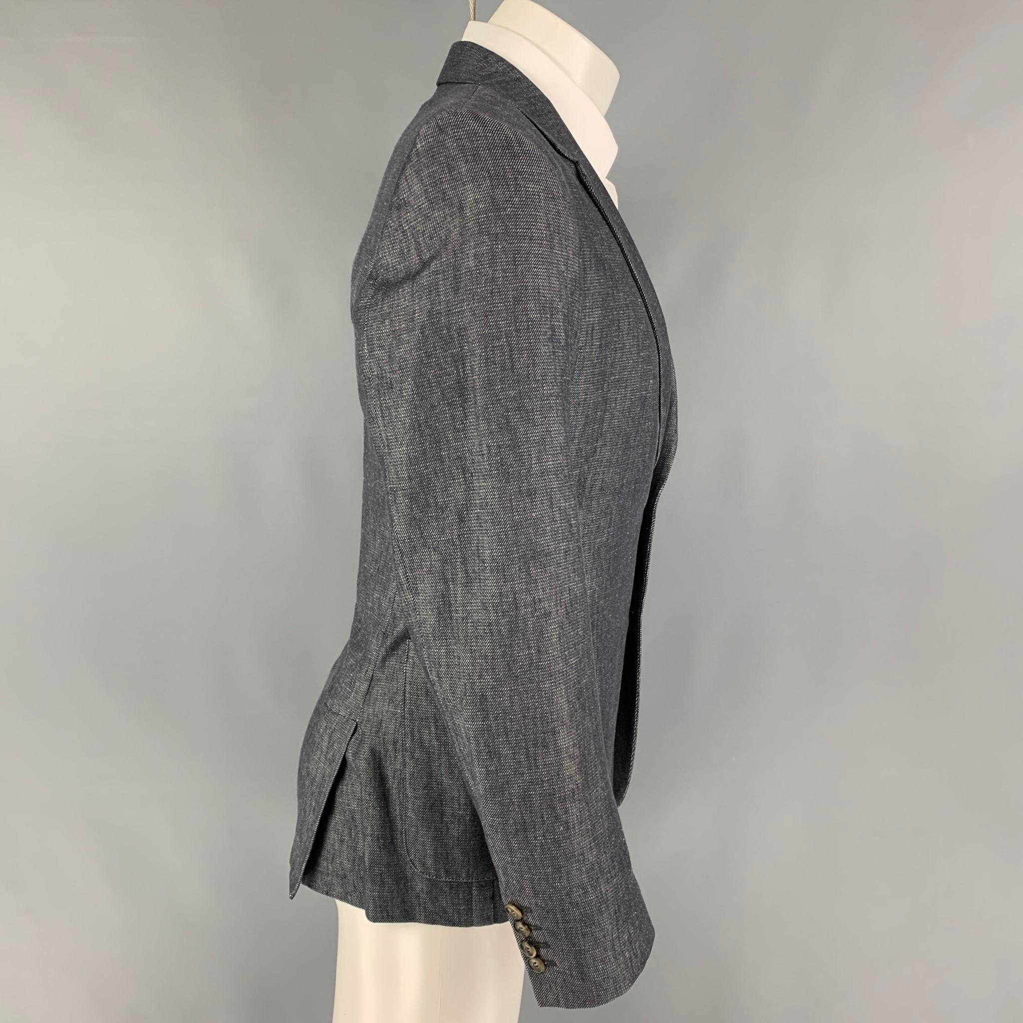AMI sport coat comes in a indigo & white twill polyamide blend with a half liner featuring a notch lapel, patch pockets, double back vent, and a double button closure. 

Very Good Pre-Owned Condition.
Marked: 52

Measurements:

Shoulder: 17