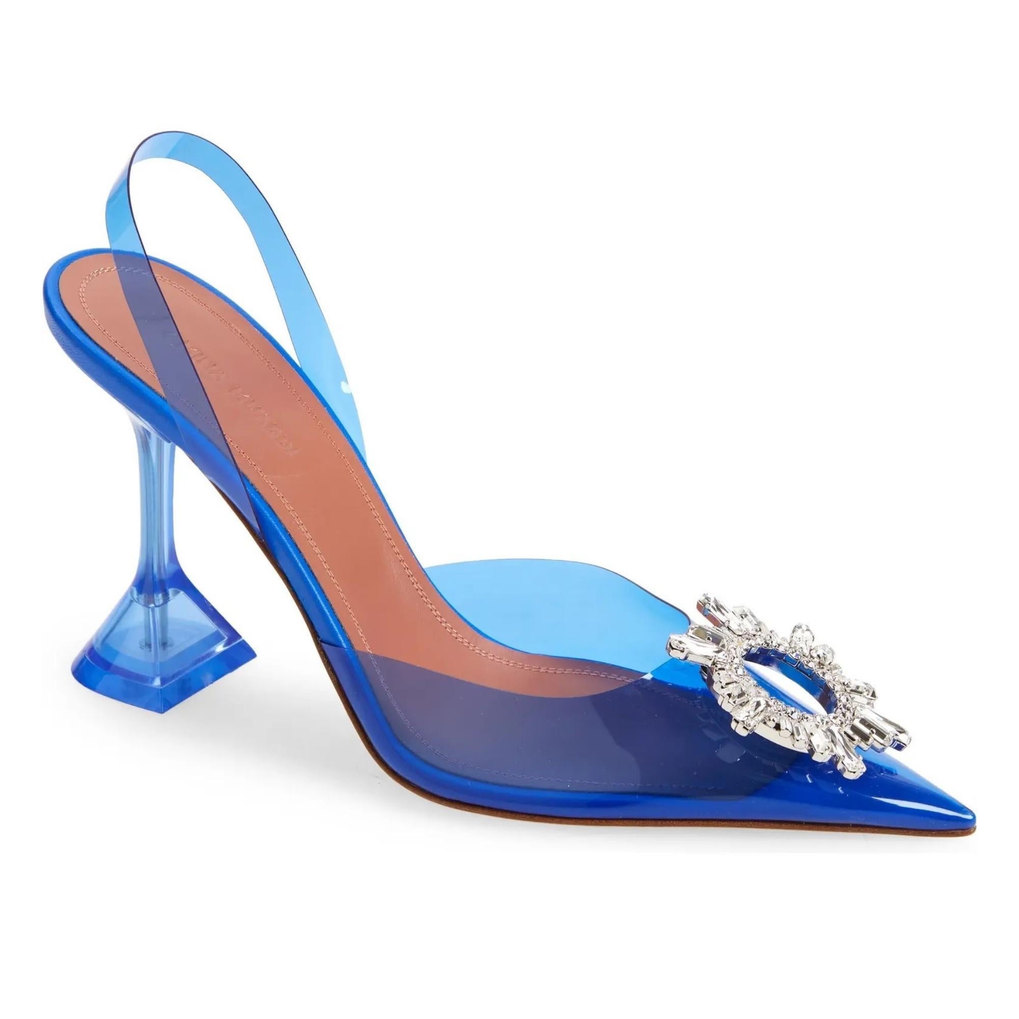 Amina Muaddi Begum PVC Slingback Blue (EU 41  US 10)

This glassy pointy-toe slingback is glammed up with a bejeweled brooch inspired by an art deco sunburst mirror. The signature flared heel has the look of a stiletto, but is more comfortable and