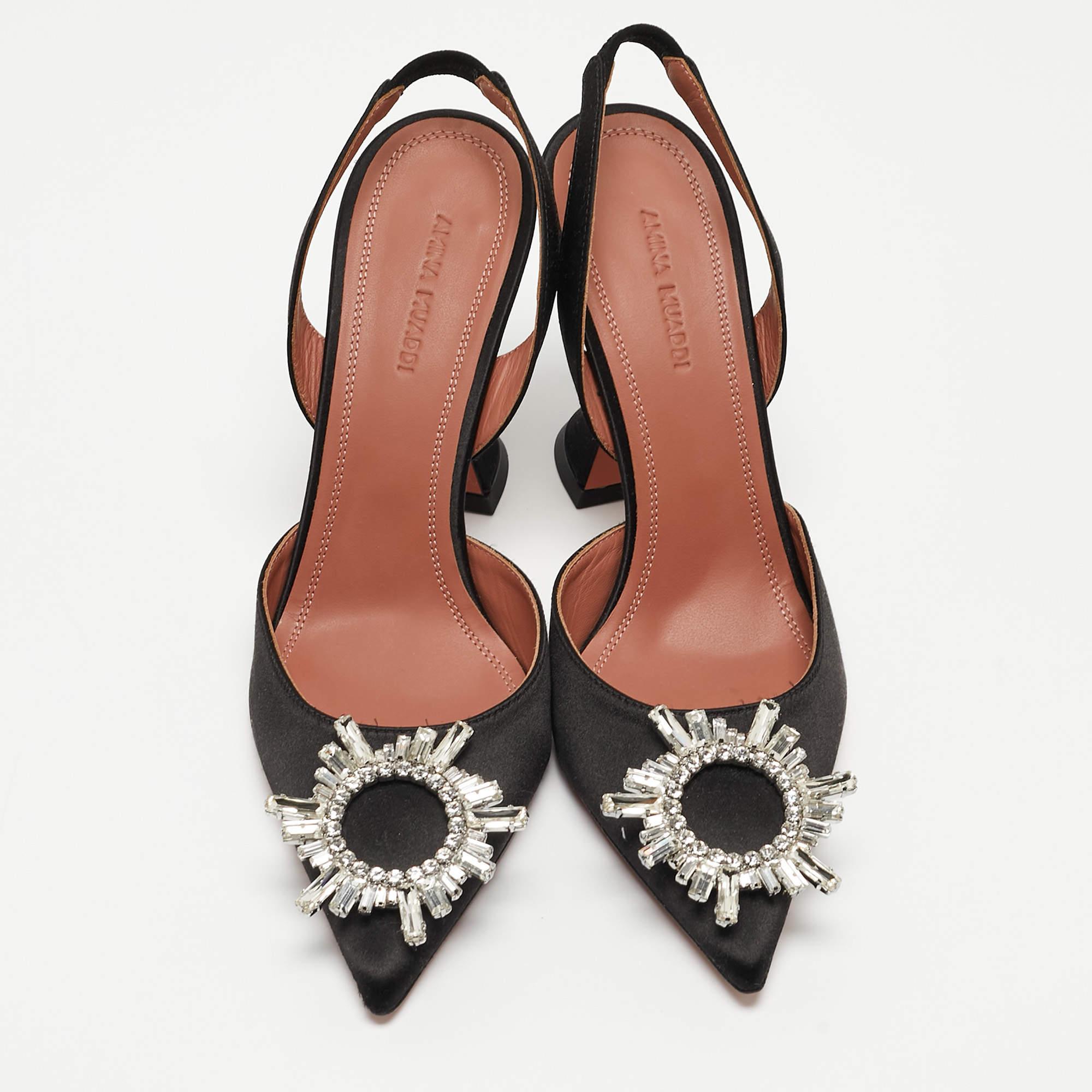 Innovative and timeless, this pair of Amina Muaddi pumps are a modern take on fairy-tale shoes. The architectural silhouette of the pair is balanced on fluted heels and the crystal-embellished butterfly bow design decorates its front. Crafted from