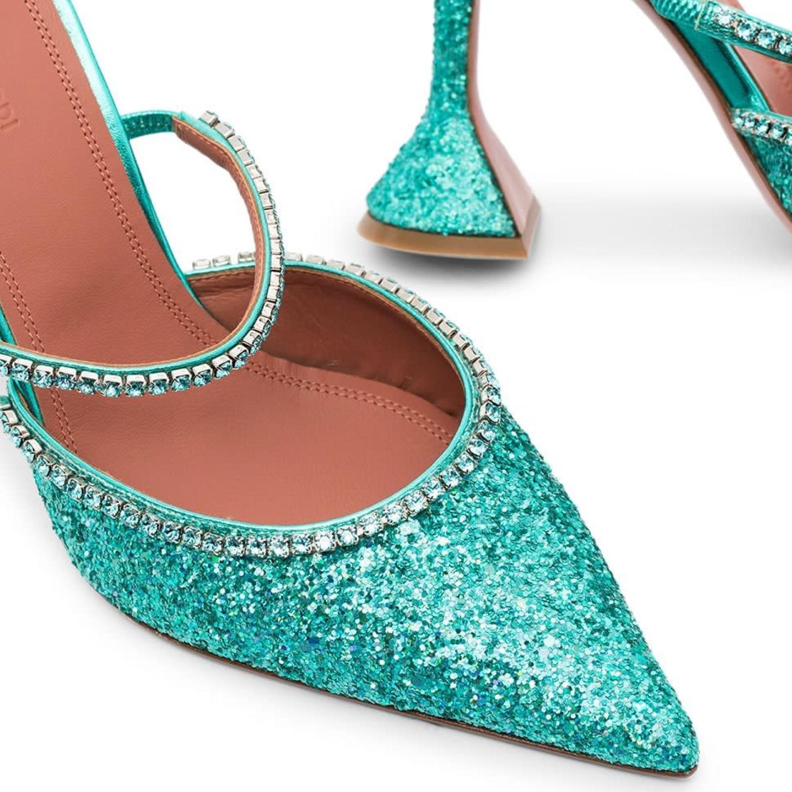 These Amina Muaddi Gilda 95 glitter mules in Mermaid color pointed toes, crystal trims to the vamp and straps, and 95 mm heels with sculpted bases. SS20
Style ID: 14770256 / GILDAMULEGLITTER

COLOR: Mermaid (blueish green)
MATERIALS: Leather, PVC,