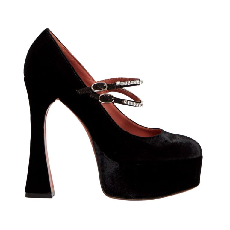 The Mary Jane Velvet Platform Heels from luxury shoe designer Amina Muaddi are a twist to the classic Mary Jane pumps and feature crossover straps embellished with crystals, a leather sole, and leather lining. The model is set on a 5.5” heel and is