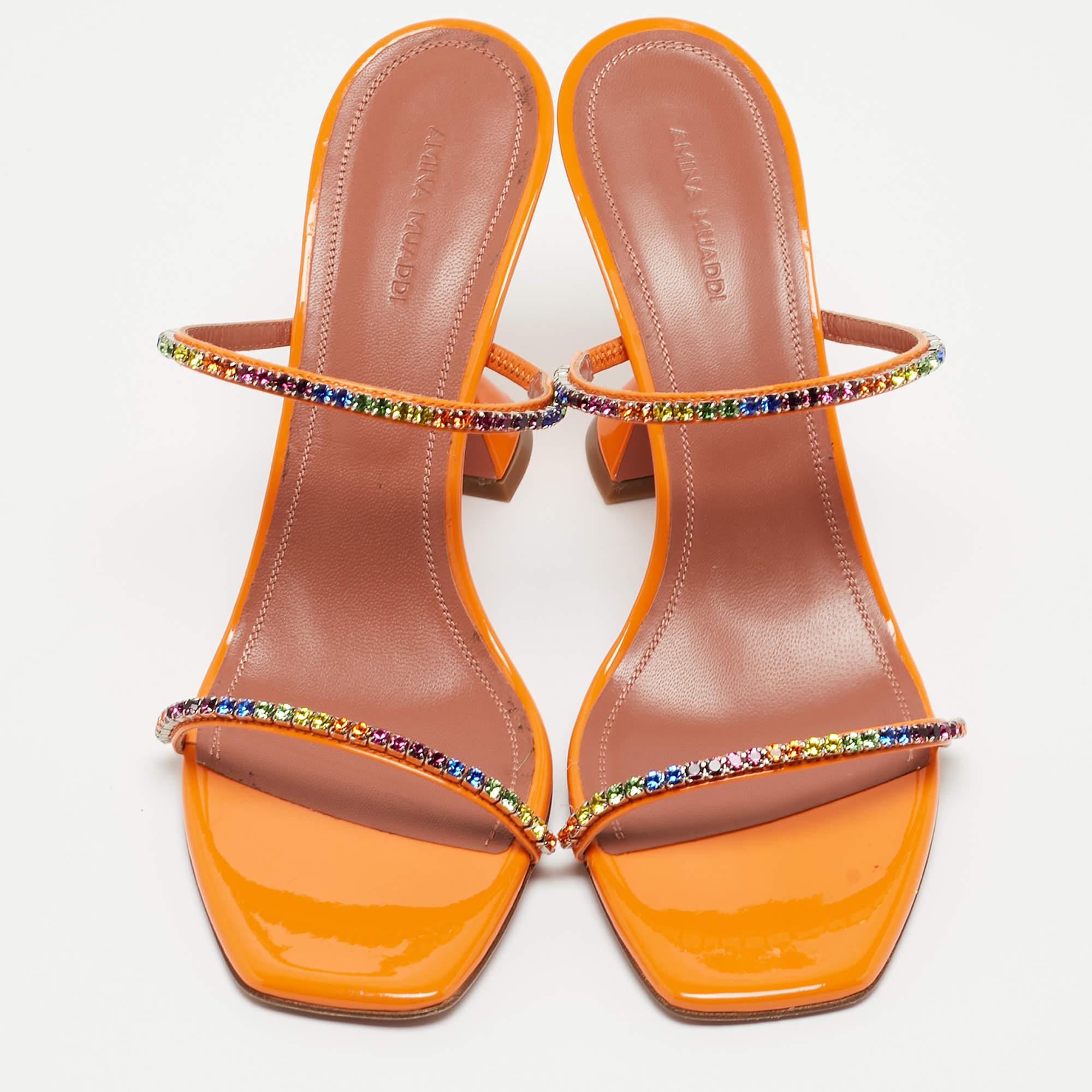 Step into the world of luxury and comfort with these Amina Muaddi sandals. Detailed with two embellished straps and signature heels, these slides will add a glam finish.

Includes: Original Dustbag, Original Box

