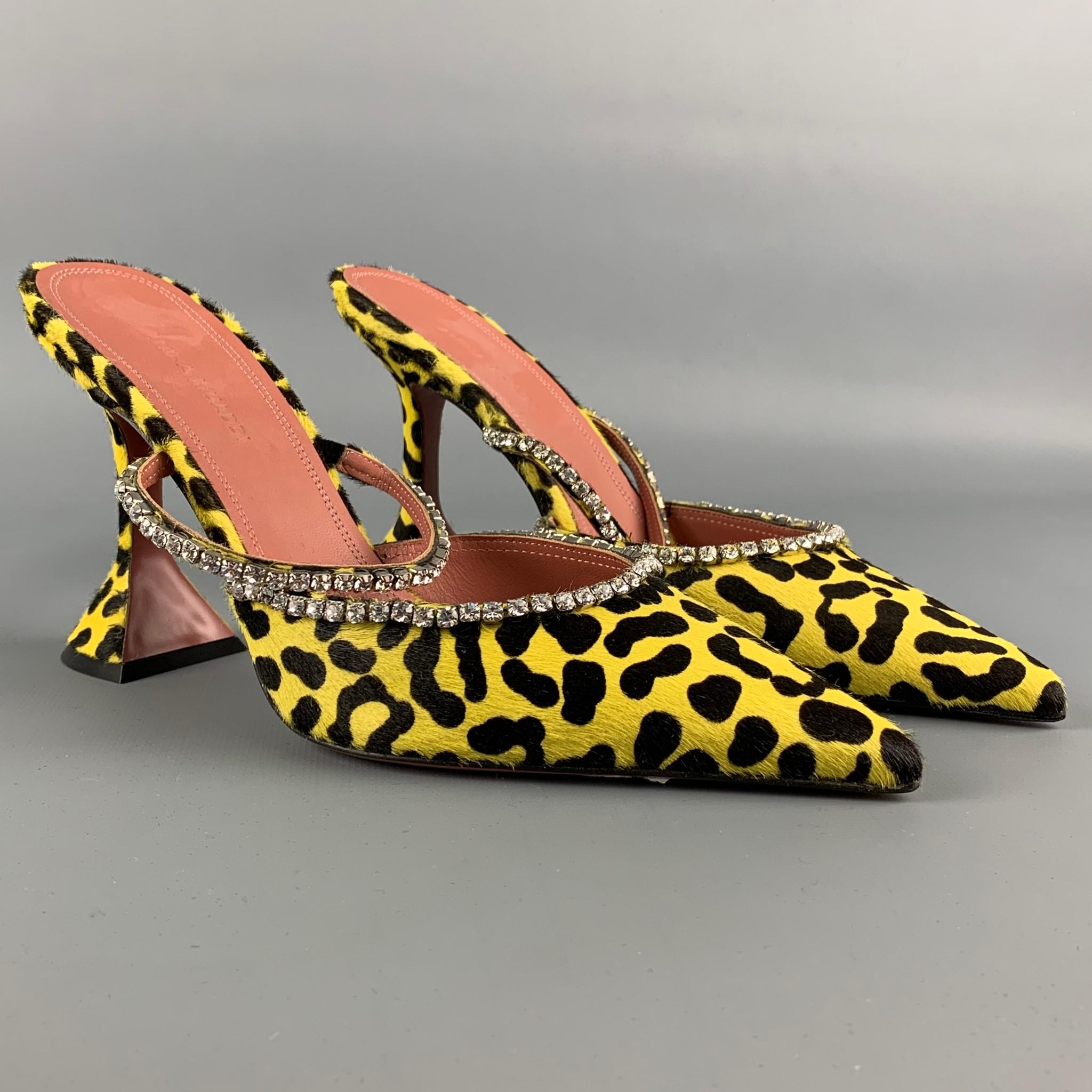 AMINA MUADDI pumps comes in a yellow & black animal print pony hair featuring a rhinestone strap detail, slip on, pointed toe, hourglass heel, and a wooden sole. Made in Italy.

New With Tags.
Marked: 38
Original Retail Price: