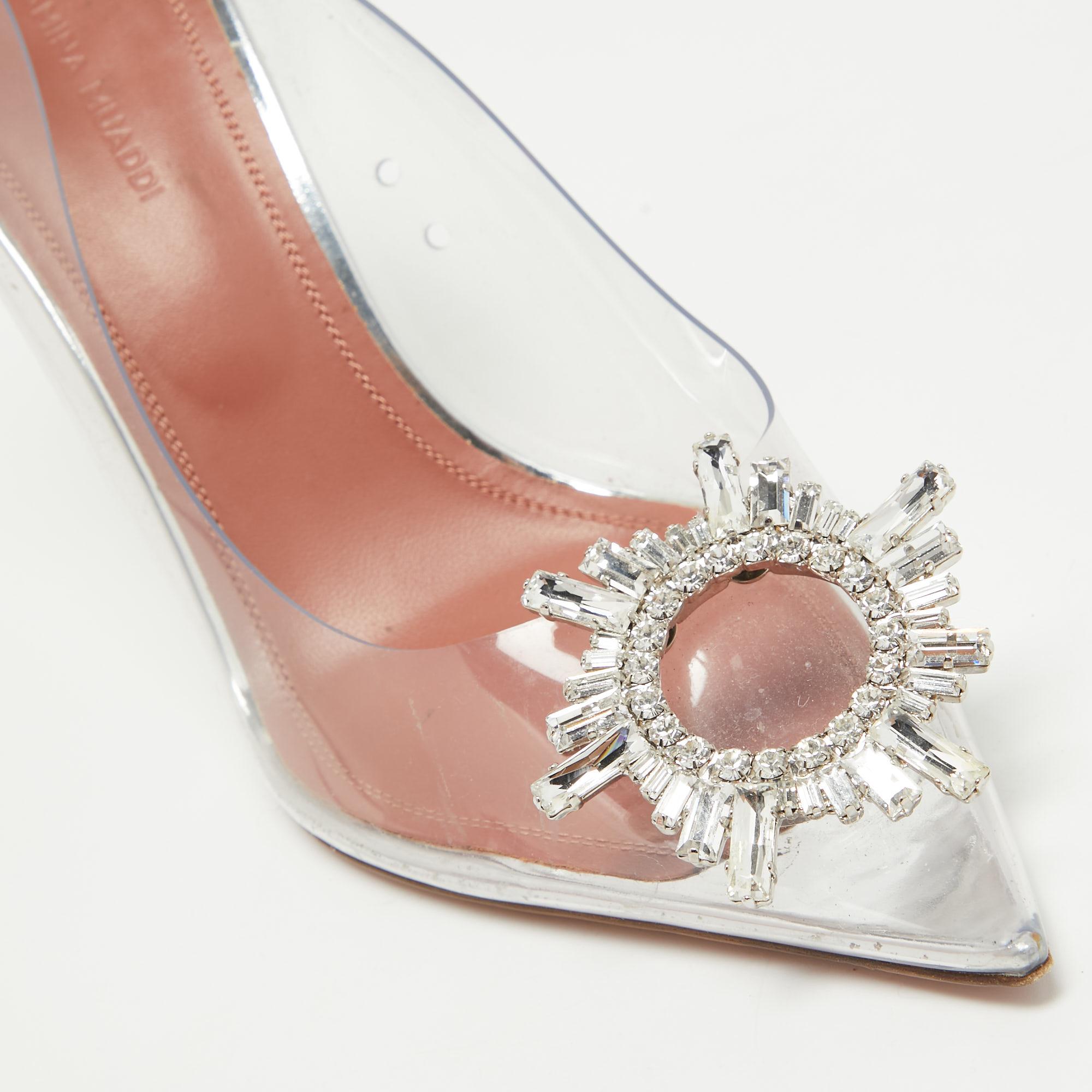 Innovative and timeless, these Amina Muaddi pumps are a modern take on fairy-tale shoes. The architectural silhouette of the pair is balanced on fluted heels and the crystal-embellished butterfly bow design decorates its front. Crafted from PVC, the