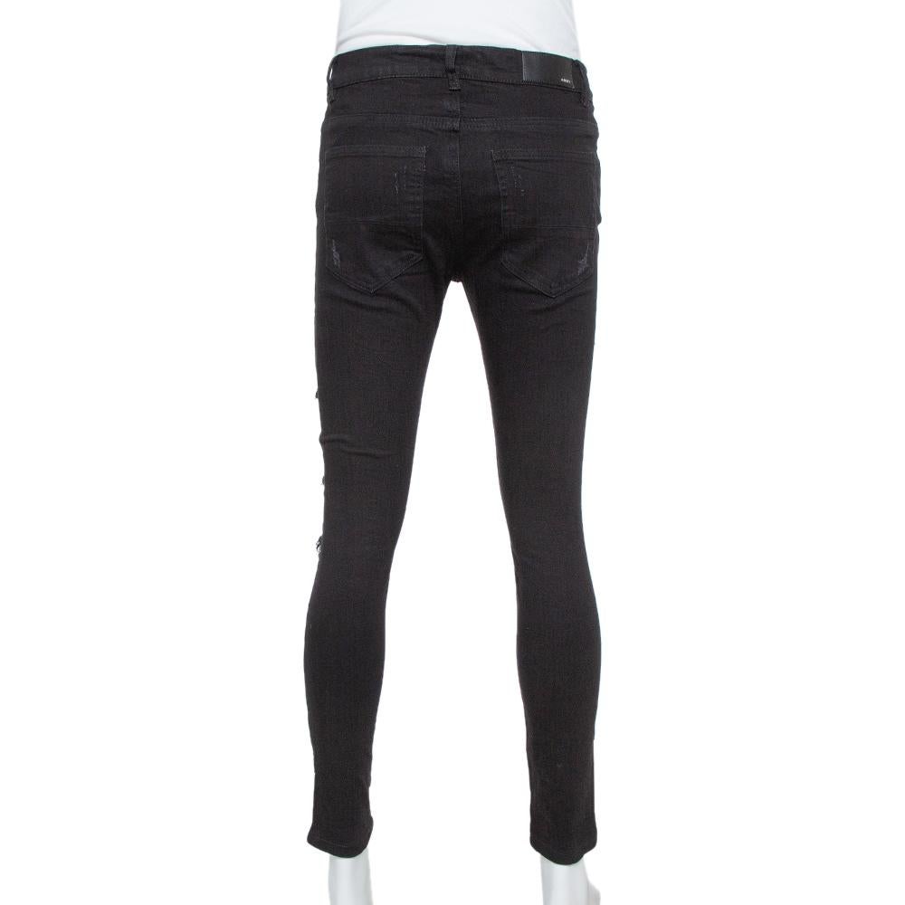 For days of ease and casual style, this pair of Amiri jeans will be just right. Made from a cotton blend, the black denim jeans come with distressed details, patches featuring musical notes, pockets, and front closure. The pair will offer you a