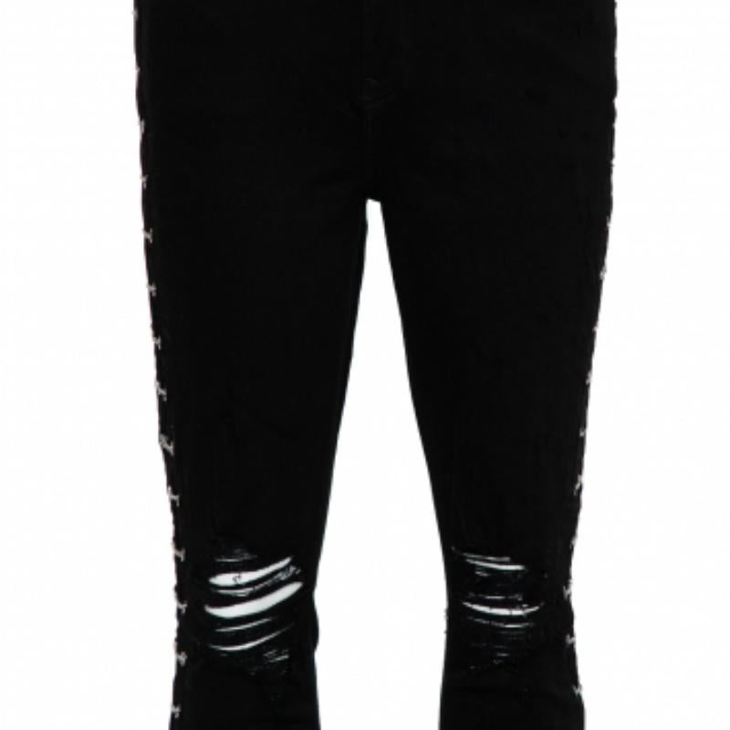 Amiri's skinny jeans are inspired by a rock n roll aesthetic! These denim pants come in a black shade and feature a distressed effect around the knees. The chain detail runs throughout the sides for a rock-chic effect. Team it up with a crop top and