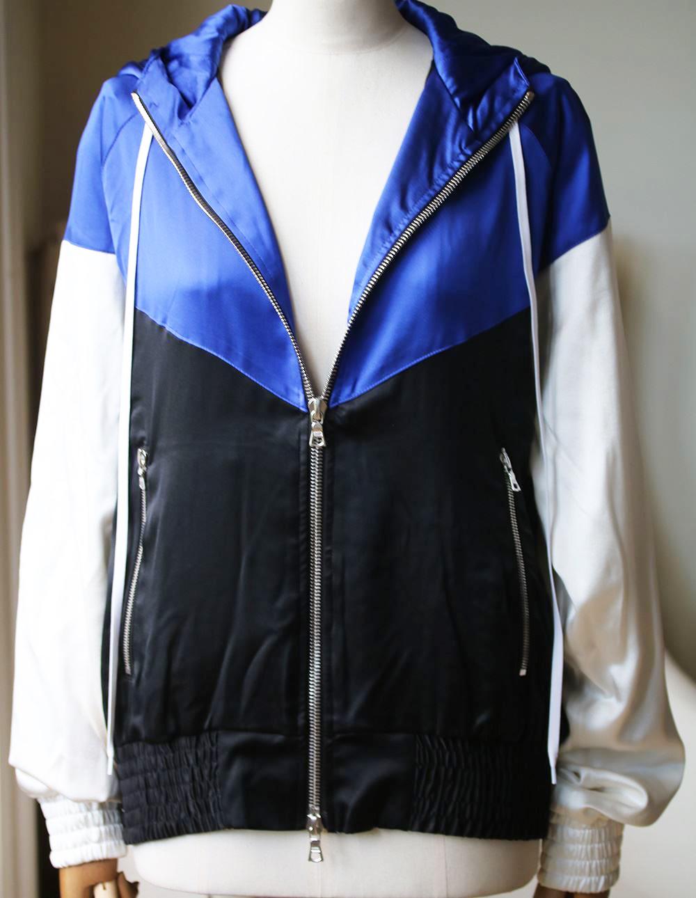 High-shine in glossy silk, this blue, white and black bomber is a youthful layer from Amiri. A hood keeps it practical while the relaxed fit works with denim or contrasted against sharp tailoring for a contemporary clash. 100% Silk.

Size: Small (UK