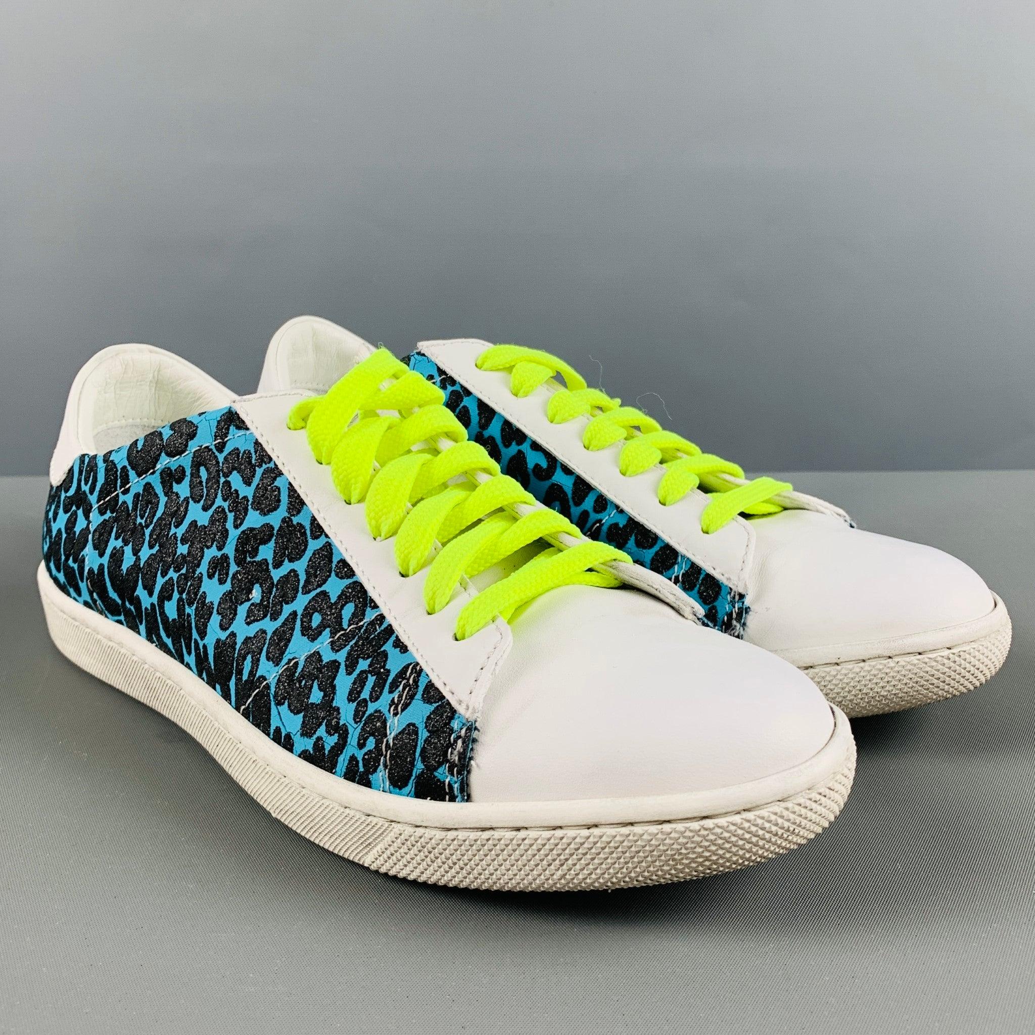 AMIRI sneakers comes in a black, white and blue leather featuring a low-top style, animal print texture, and a neon lace up closure. Comes with Box. Made in Italy.Very Good Pre-Owned Condition.  

Marked:   37Outsole: 10.5 inches  x 3.5 inches 
  
 