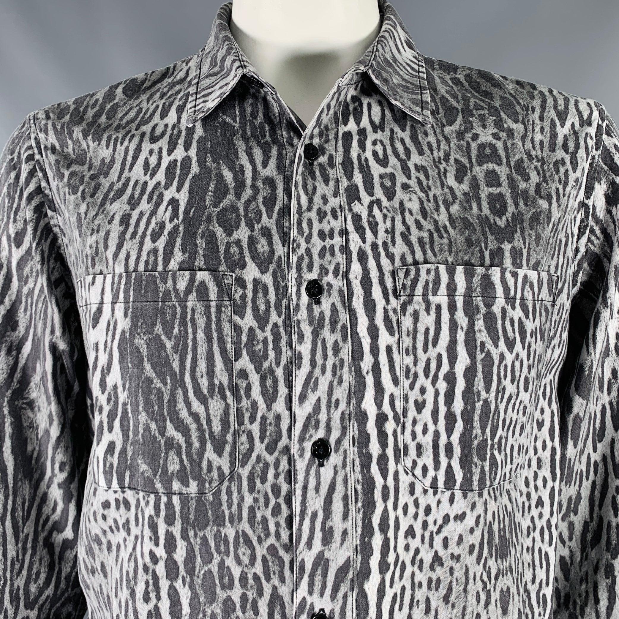 AMIRI long sleeve shirt
in a grey and black cotton woven fabric featuring an animal print, frayed hem design, two chest pockets, and button closure. Made in USA.Excellent Pre-Owned Condition. 

Marked:   L 

Measurements: 
 
Shoulder: 18 inches