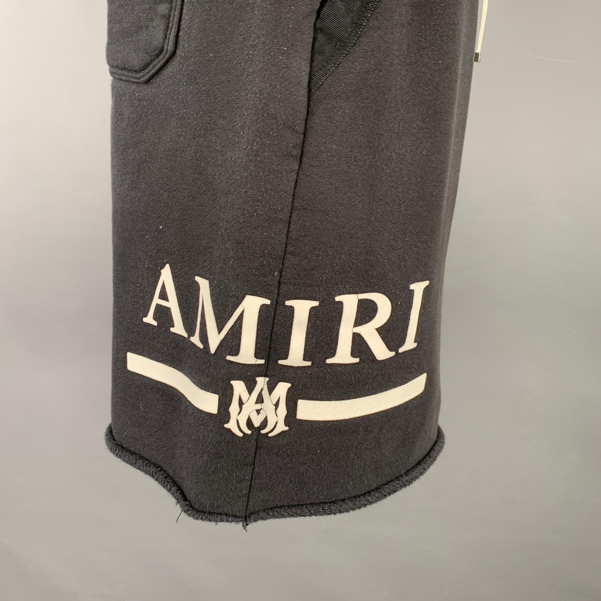 AMIRI shorts
in a black cotton featuring white logo print on side, athletic style, and drawstring closure. Made in USA.Excellent Pre-Owned Condition. 

Marked:   IT 52 

Measurements: 
  Waist: 34 - 38 inches Rise: 11 inches Inseam: 7.5 inches 
  
 