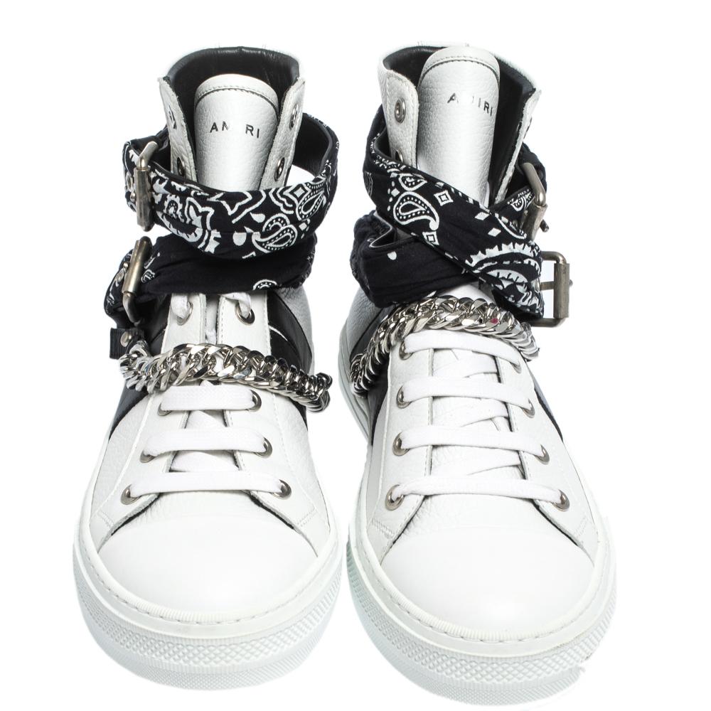 A blend of style and bold simplicity, these high-top sneakers from Amiri will smartly complement your casual ensemble. Crafted with black and white leather, the sneakers are characterised by the interesting bandana and chain detail adorning the