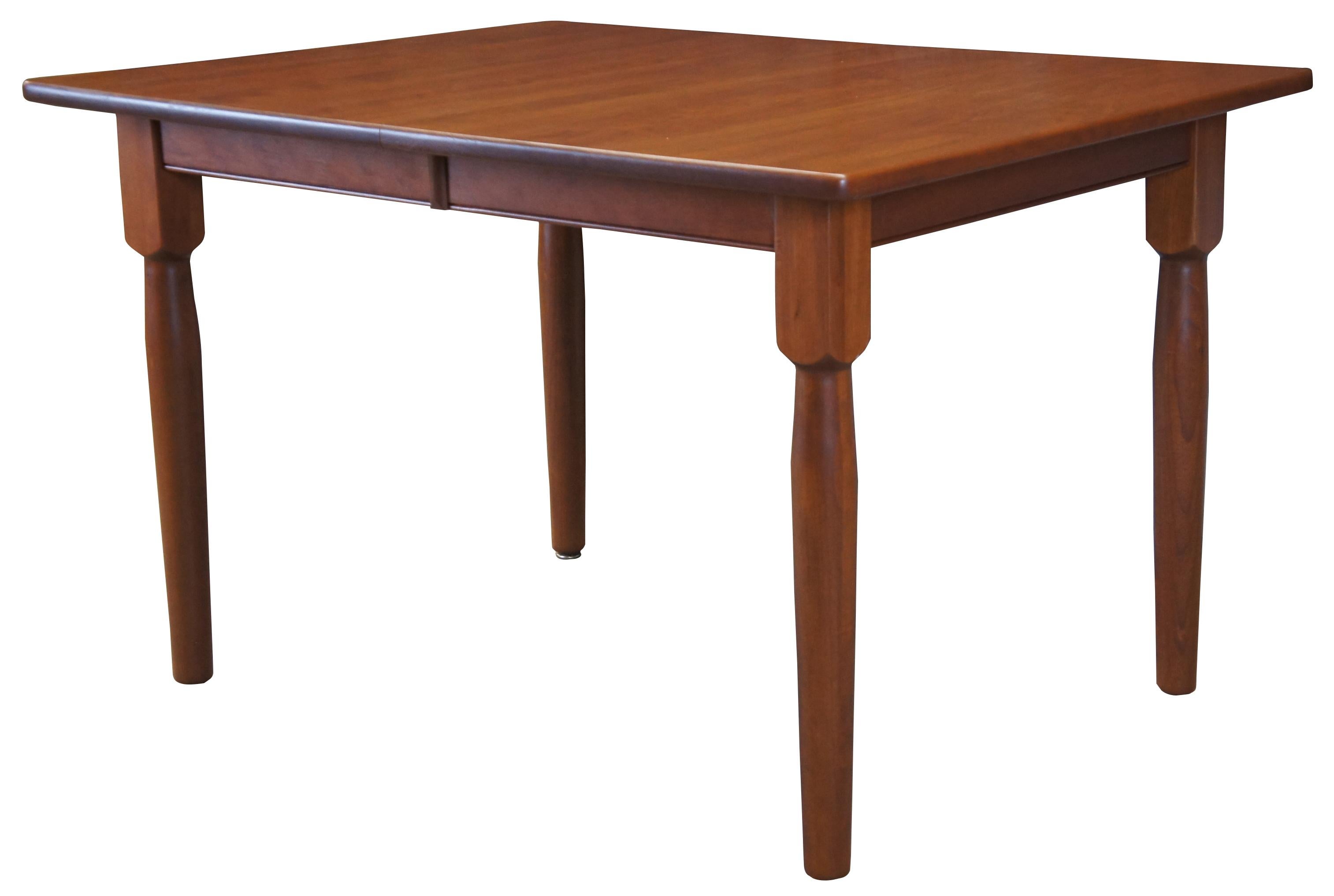 Amish made handcrafted cherry dining table. Rectangular form with turned legs. Features (3) 11
