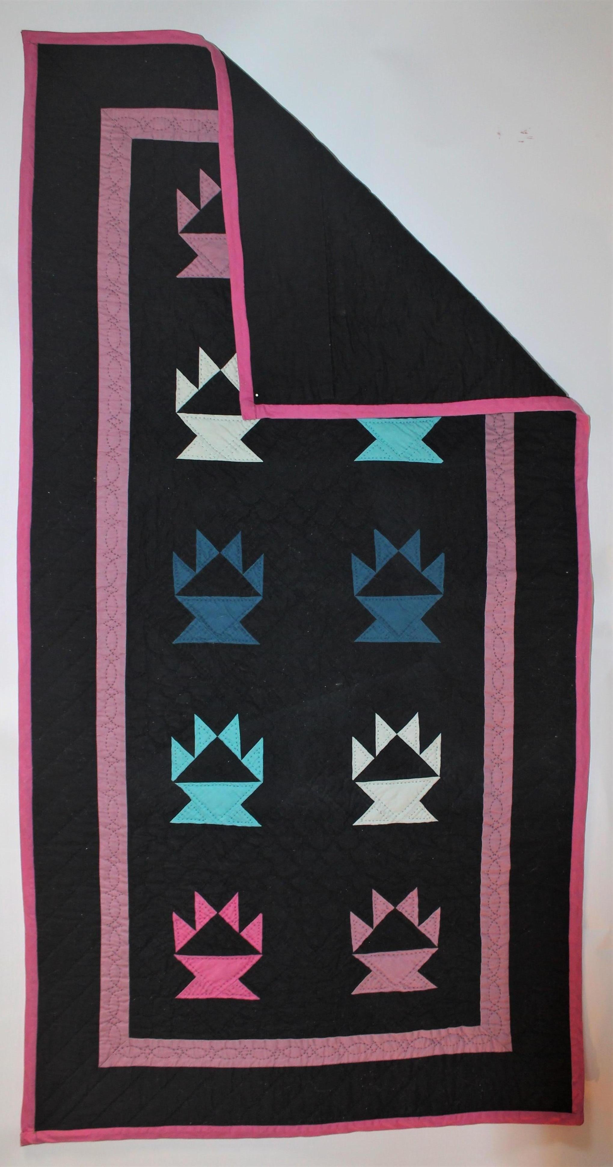 This is such a rarity crib or cradle quilt from Holmes County, Ohio. These gem tone colors on a black cotton ground and such nice quilting and piecing. The condition is pristine.