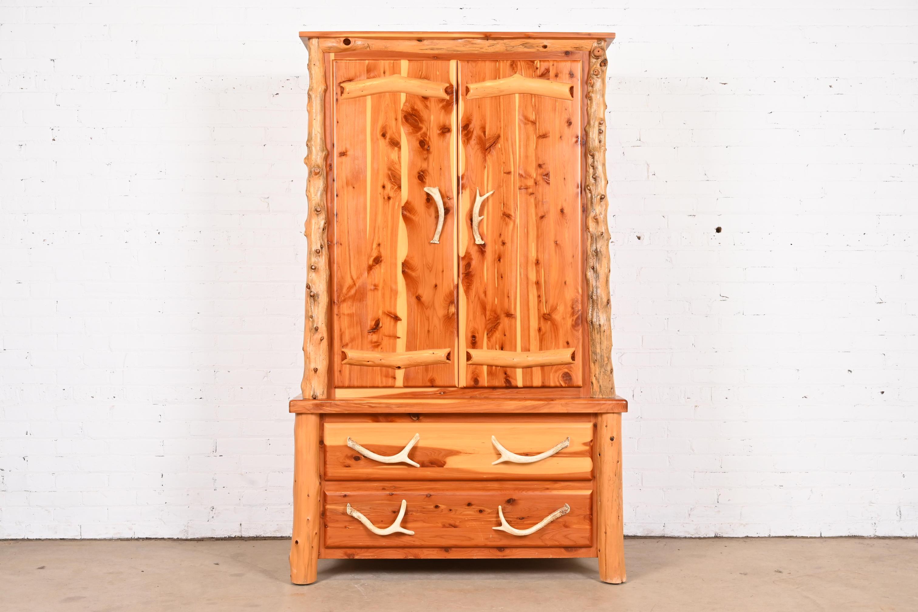 An exceptional Amish made handcrafted rustic lodge two-piece armoire dresser or wardrobe

USA, Circa Late 20th Century

Gorgeous cedar wood, with faux antler hardware.

Measures: 45
