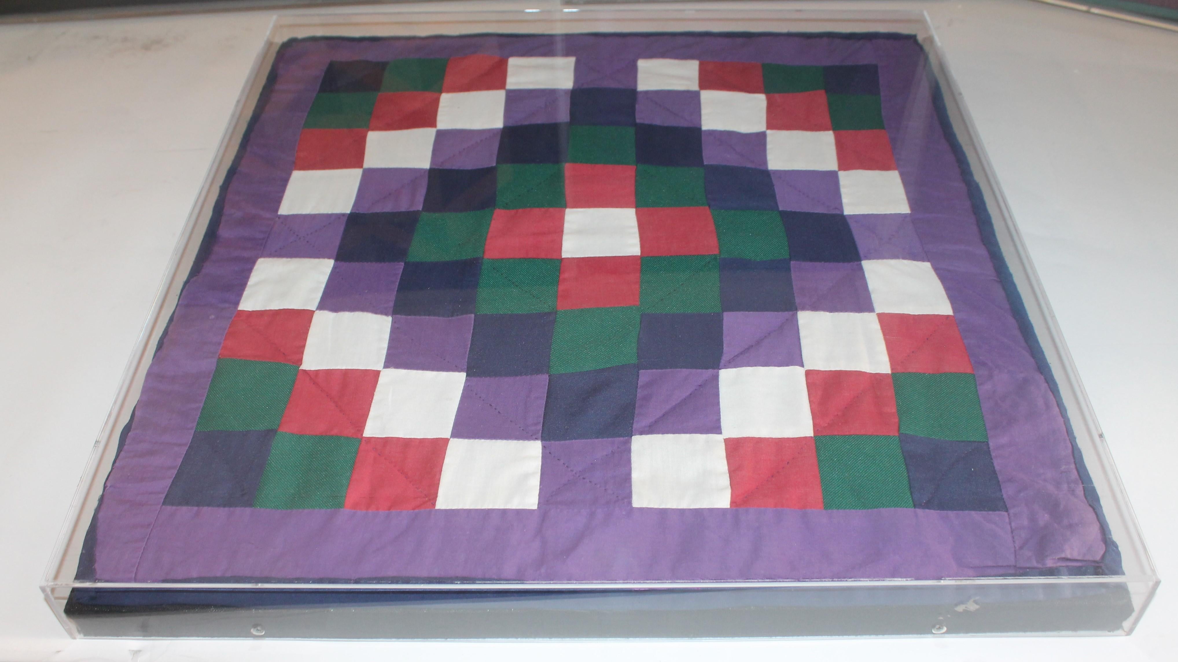 1940s made Amish doll quilts sewn on a stretcher with in plexi-glass and each quilt is in in pristine condition.