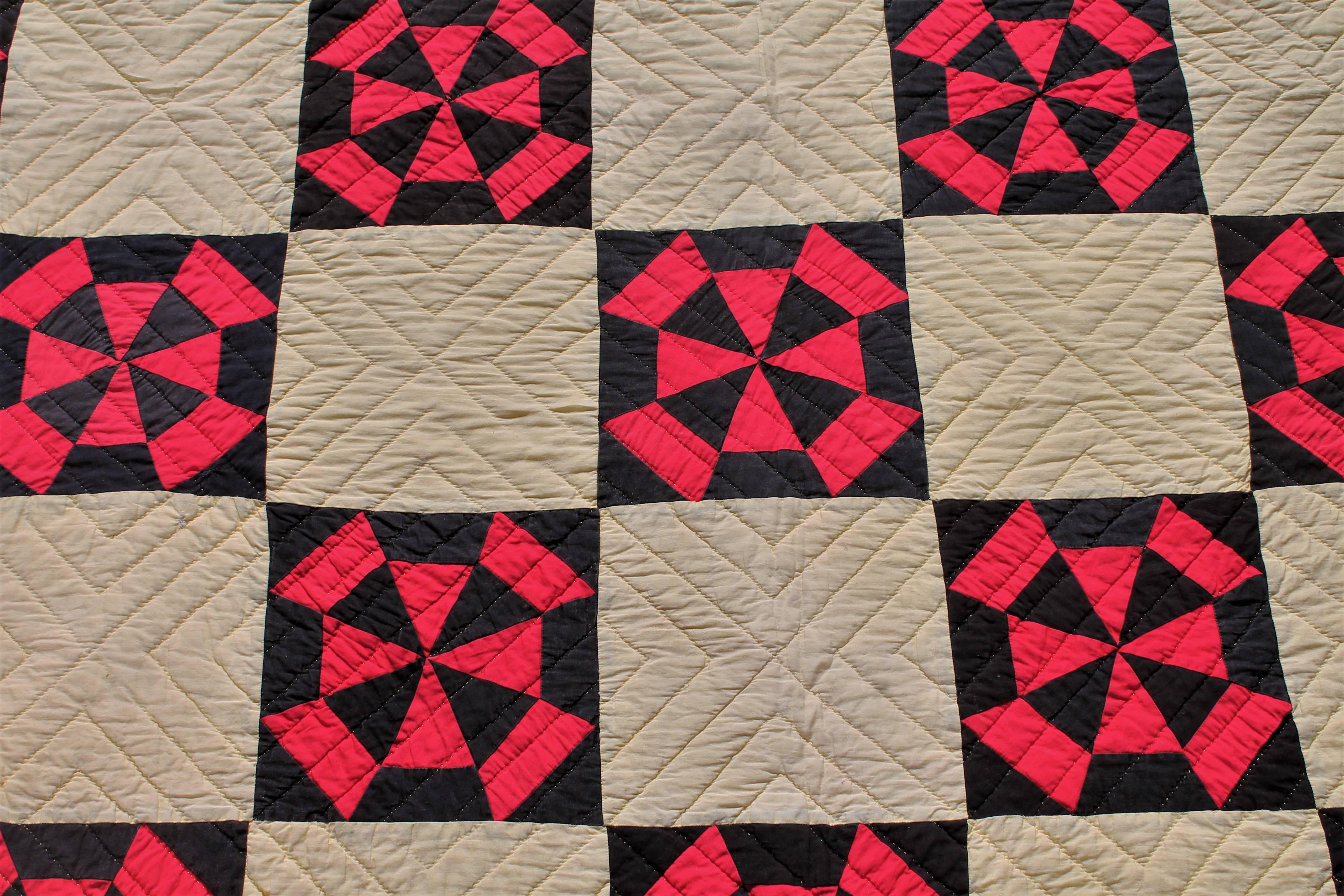 This fine large black and red pinwheel pattern quilt is in good condition with a double inner border and very nice piece work. The quilt has nice tight quilting and is supper graphic.