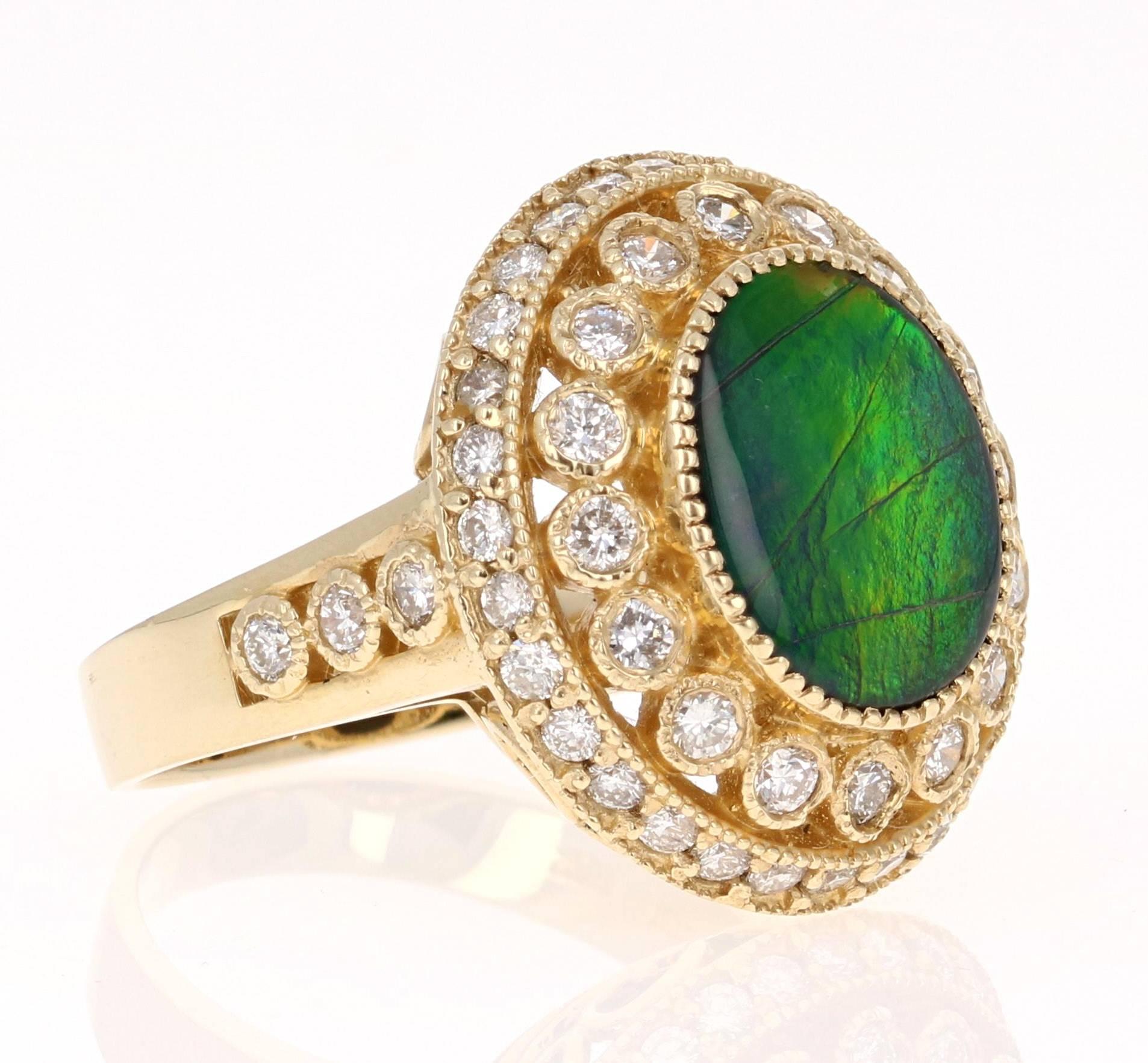 This elegant and royal ring has a beautiful 3.10 carat Oval Cut Ammolite in the center of the ring. Ammolite is an Opal-like organic gemstone that is primarily found in the eastern slopes of the North American Rocky Mountains. This particular