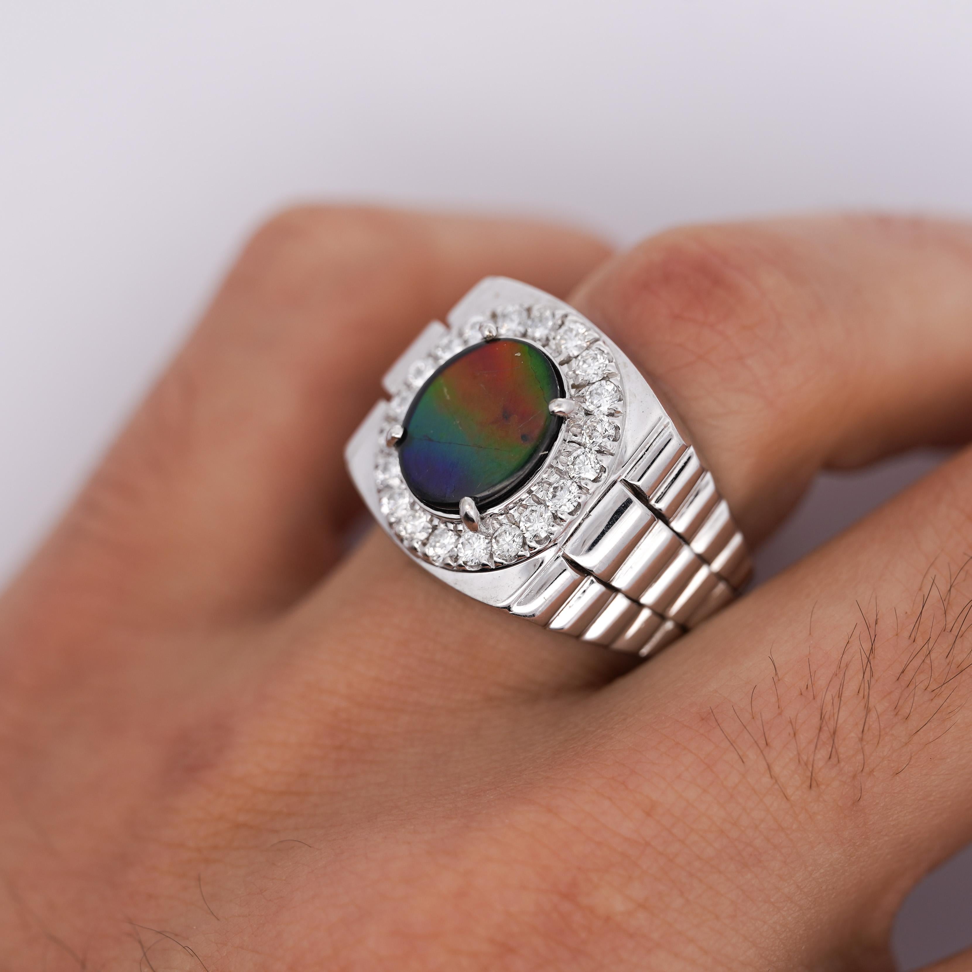 14K White Gold with Ammolite and Diamond Halo Men's Statement Ring in Size 10.5

Details:
Item Type: Men's Statement Ring
Metal: 14K White Gold
Size: 10.5 (adjustable)
Weight: 13.7 Grams

Center Stone Details:
Type: Ammolite
Measurements: 12 x
