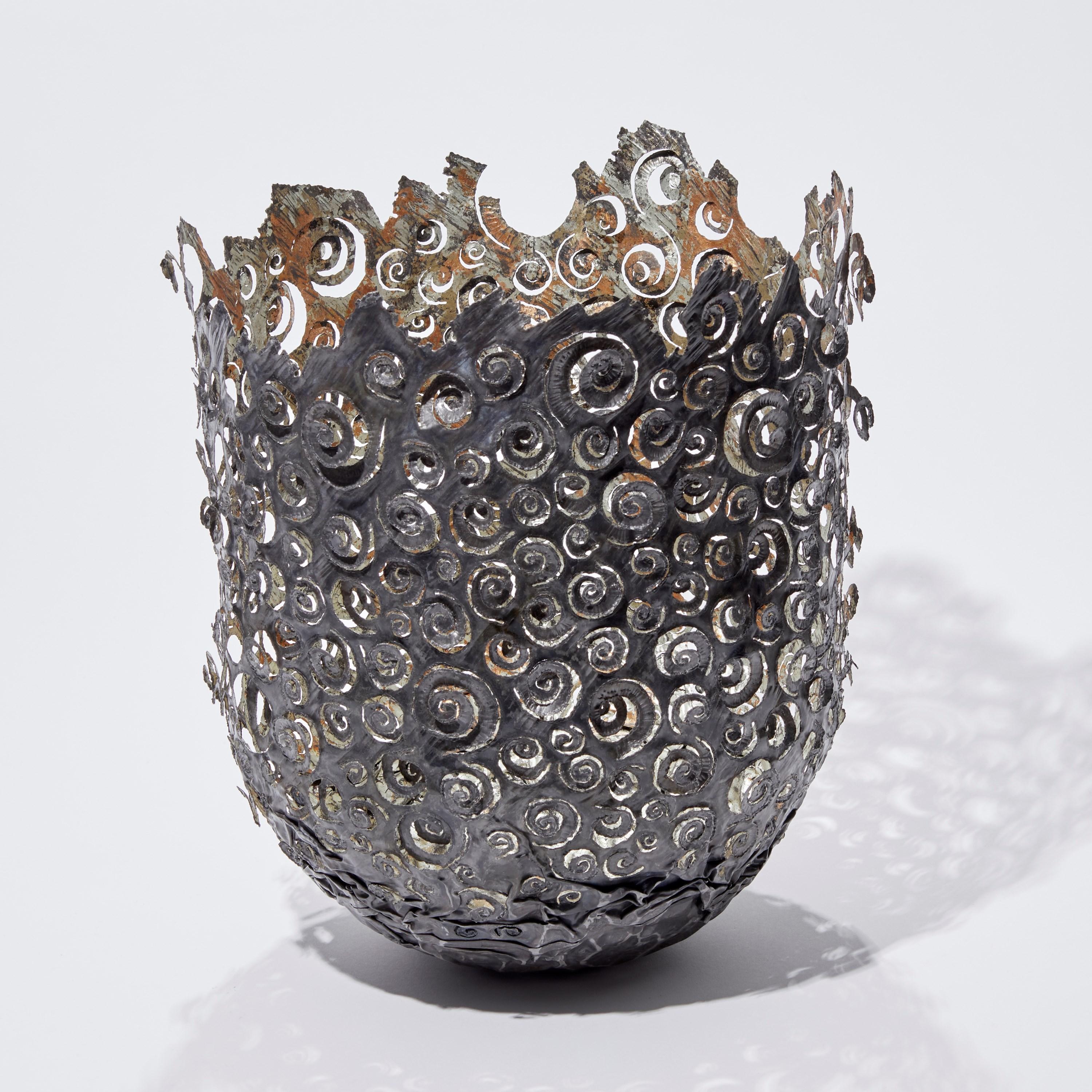 Ammonite vessel is a unique steel & moon gold sculptural vessel by the British artist Claire Malet. Created from an oxidised re-formed steel can and hand-gilded on the interior with 22ct moon gold and copper leaf, the final piece has been lacquered