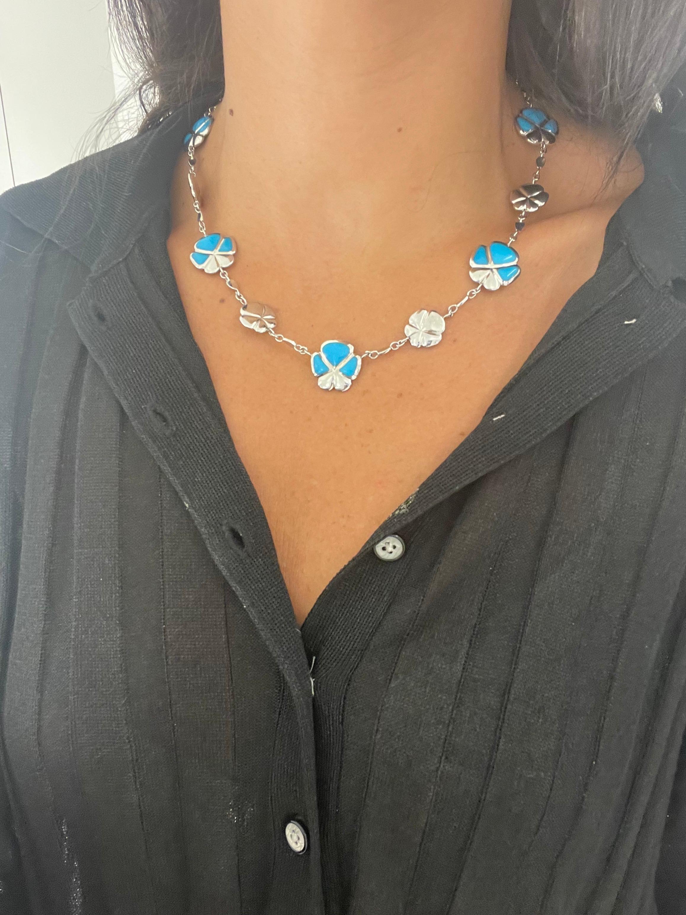 Created by famed Italian Jewelers, De AMBROSI, exclusively for Cellini Jewelers this flower necklace is inlaid with turquoise alternating with small white gold flowers. As a show of the excellent craftsmanship the flowers are completely reversible,
