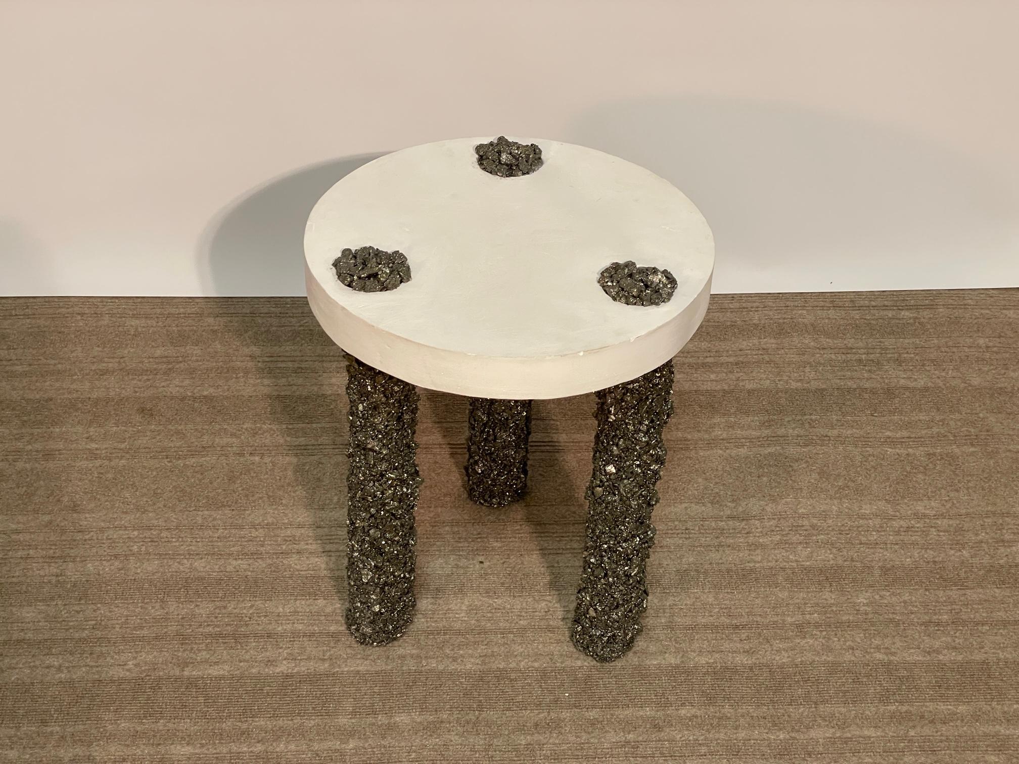 Hand made plastic-finished steel top supported by three substantial Pyrite legs create a very organic and energetic small side table or cocktail table.  A great conversation piece and functional table, this piece by Amoia Studio can stand out in a