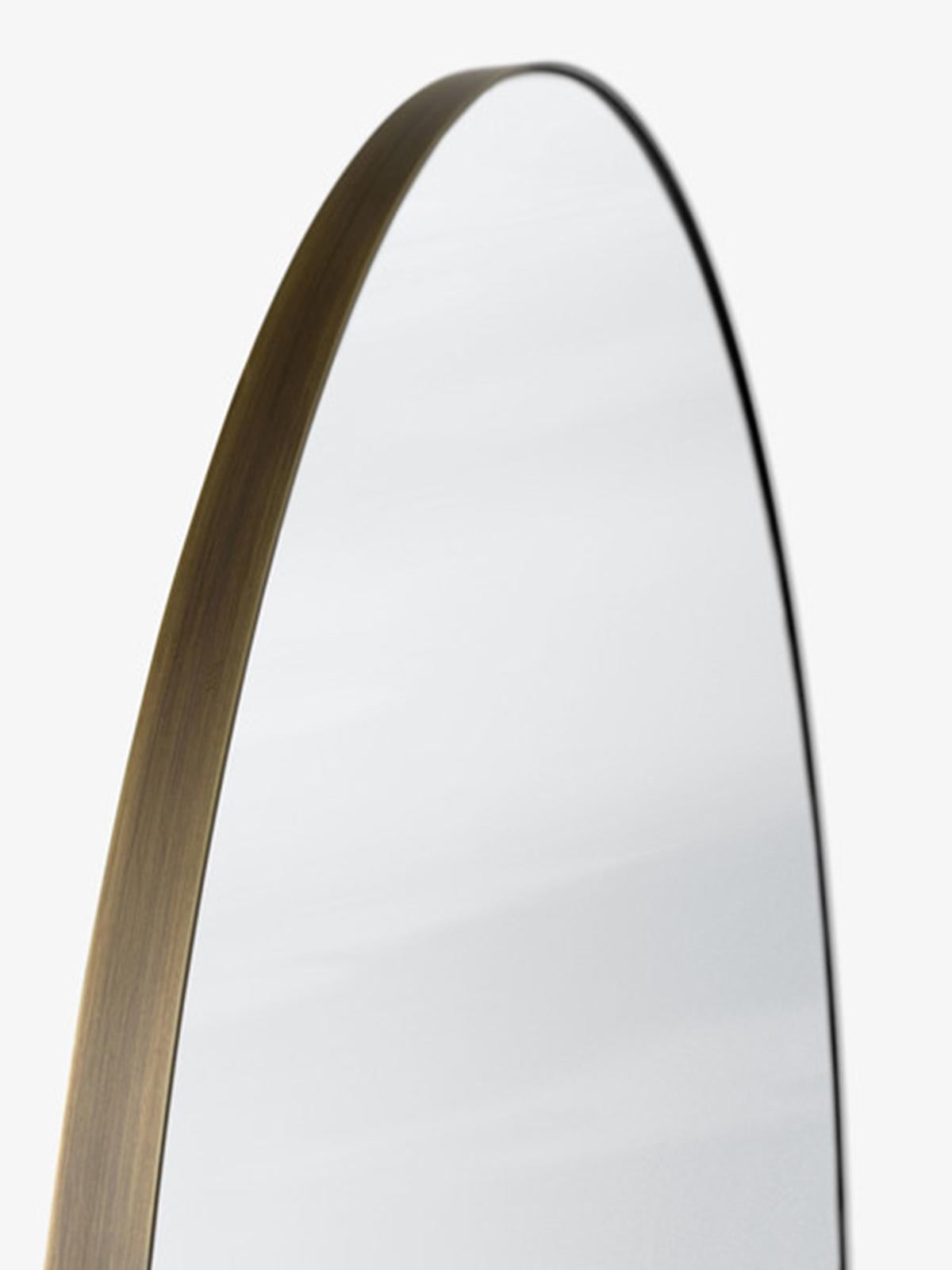 First designed for the SAS Royal Hotel in Copenhagen by Space Copenhagen, this geometric mirror comes in a circular version in Ø: 115cm/46in, D: 3cm/1.2in. 
Having a bronzed brass frame and a silver-colored mirror.