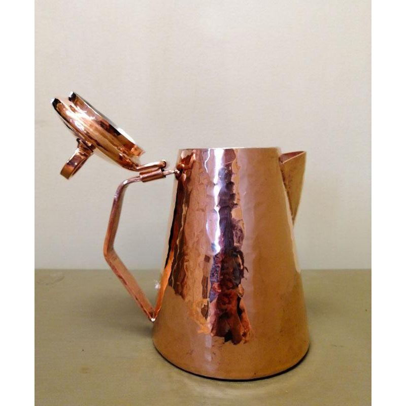 Elegant copper teapot with lid, it is handmade with hand-hammered solid recycled copper, tin-lined on the inside. 

Dimensions: H 6.3 x 4.7 (bottom) x 2.7 (diameter of the lid)
Capacity: 1.3 L
Copper gauge 1.5mm.