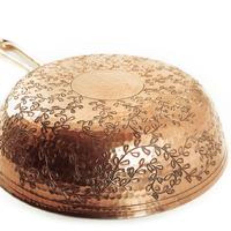 A fine copper fry pan that harkens back to Roman elegance. The classic look of the 9-inch “Leaves” Copper Fry Pan adds an elevated charm to your kitchen. Winding leaf designs cover the gleaming exterior of this fry pan. Made entirely from hand