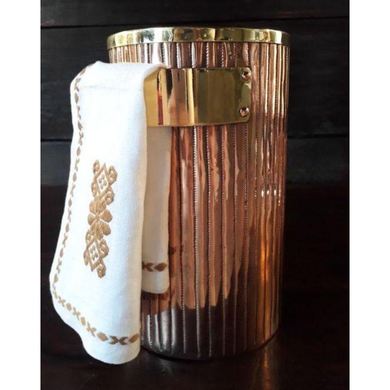 Fantastic hand-hammered copper ice bucket designed for your very important sparkling wine. The line design is hand-engraved with lines and finished with brass decors, the brass napkin holder, and the copper rivets give a sophisticated