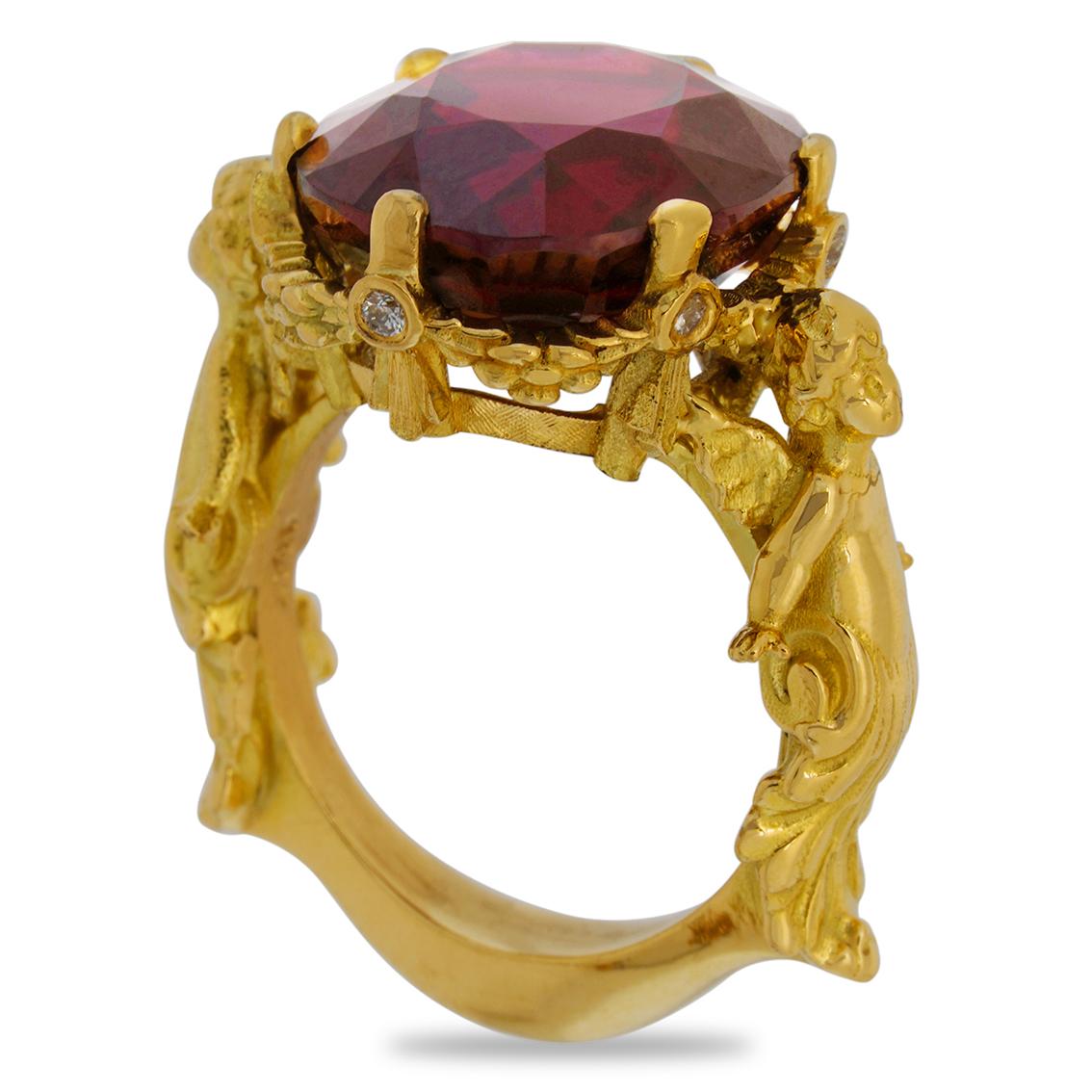 Exquisitely handcrafted in 18kt yellow gold this enrapturing ring features a rich deep bordeaux red garnet aloft a signature William Llewellyn Griffiths garland setting decorated with fine floral details. Measuring 15.5mm long x 13.5mm wide x 8.7mm