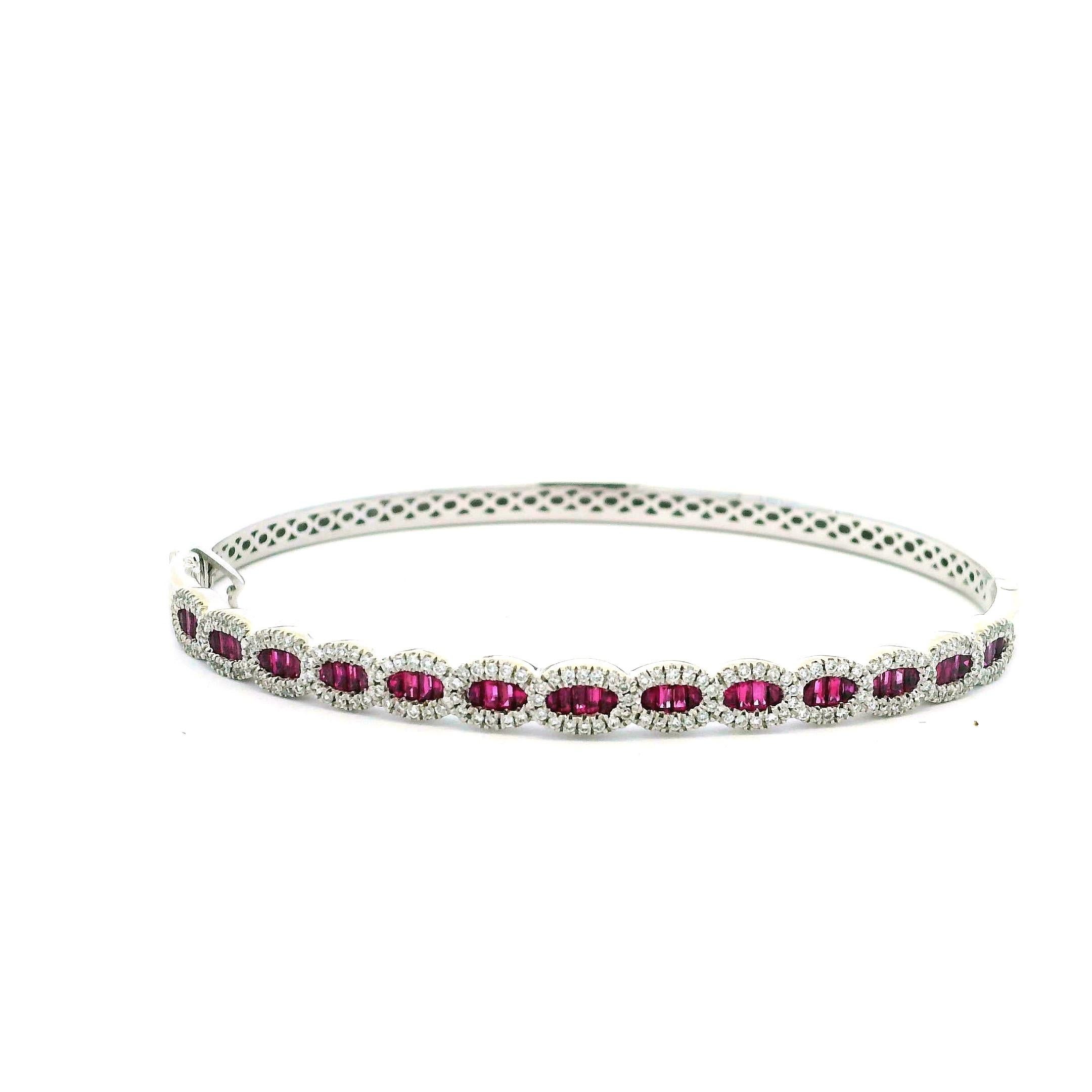 A beautifully crafted Amoro bangle bracelet in 14K white gold, featuring a stunning line of fifty-two vivid red rubies totaling approximately 1.30 carats. Each ruby is set in an elongated oval cluster and outlined by a delicate halo of 156 round