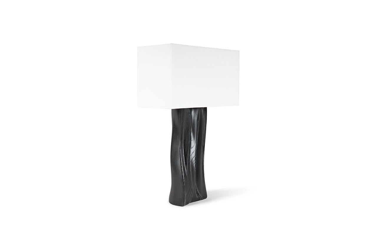 The Doris table lamp is a truly unique and stunning addition to any luxury or contemporary home. Its undulated form adds a touch of elegance and sophistication to any space. The lamp comes with a rectangular Ivory silk shade, adding a soft and warm