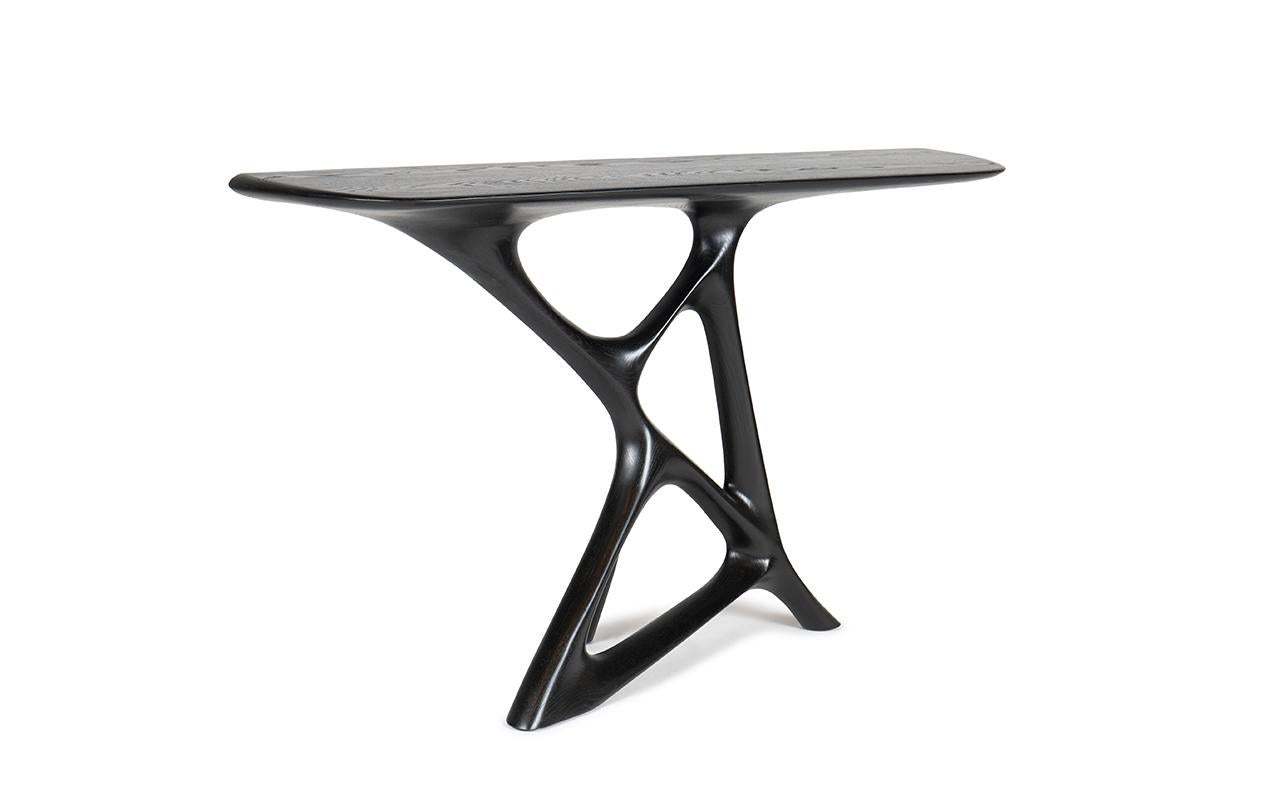 The Anika console table is a standout piece from our collection due to its unique shape and design. It is specifically designed for modern and contemporary homes, adding a touch of elegance and style to any space. The table is available in different