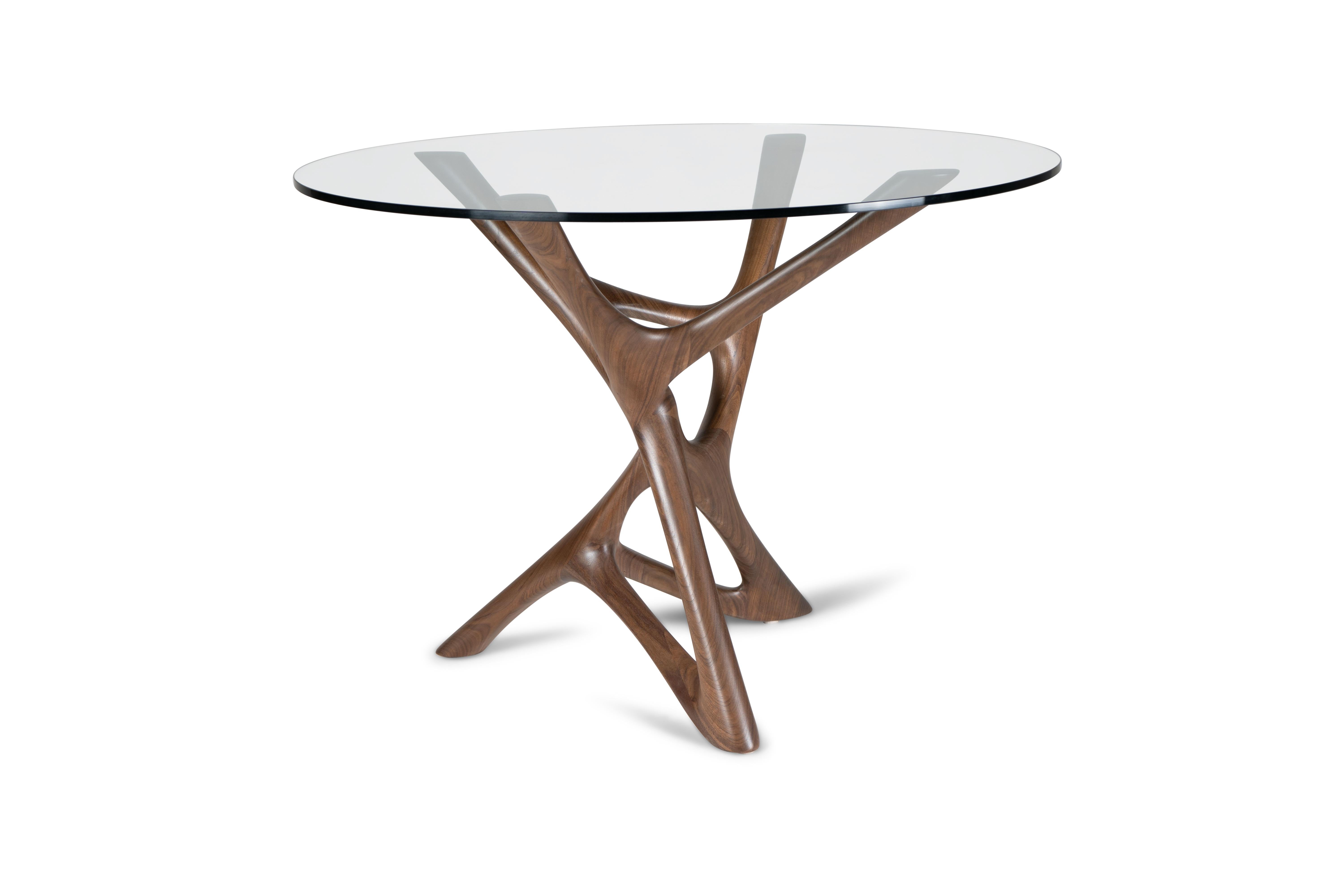 The Ava dining table is a one-of-a-kind piece that adds a touch of luxury and modernity to any contemporary home. Its unique organic shape sets it apart from traditional dining tables, giving it a dynamic and movement-inspired design. The base of