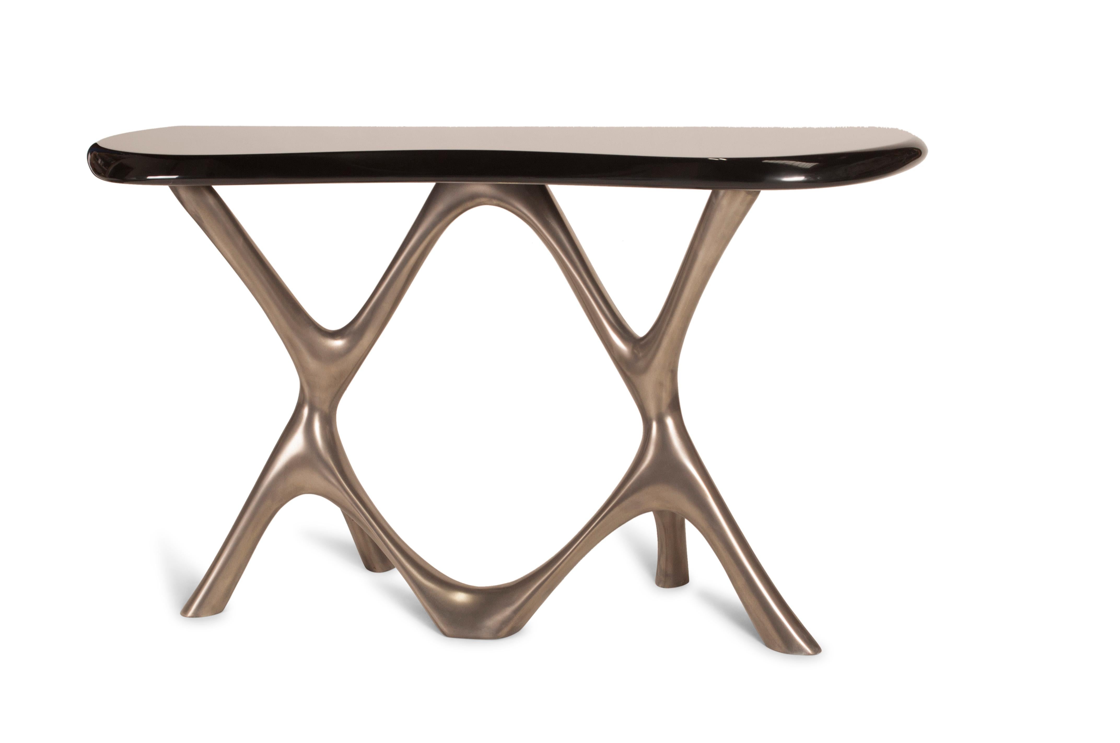 Amorph avatar console table, base: Nickel finish top surface: Glossy black lacquered

About Amorph: 
Amorph is a design and manufacturing company based in Los Angeles, California. We take pride in hand crafted designs connected to technology to