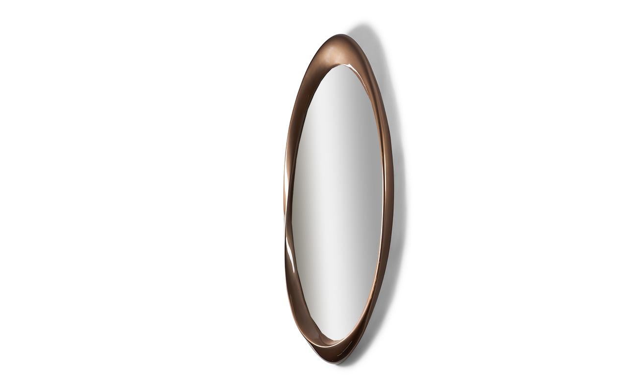 The Baris mirror offers a unique and modern design that gives the illusion of the mirror being separate from the frame. The frame appears to wrap around the mirror, creating a visually striking and contemporary look. This mirror is perfect for