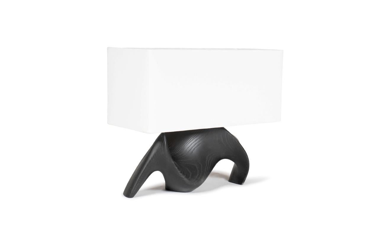 The Bonsai table lamp is a stunning addition to any luxury and modern home. Its curvy organic shape adds a touch of elegance and sophistication to any room. With its different finishes or custom shade options, you can customize the lamp to perfectly