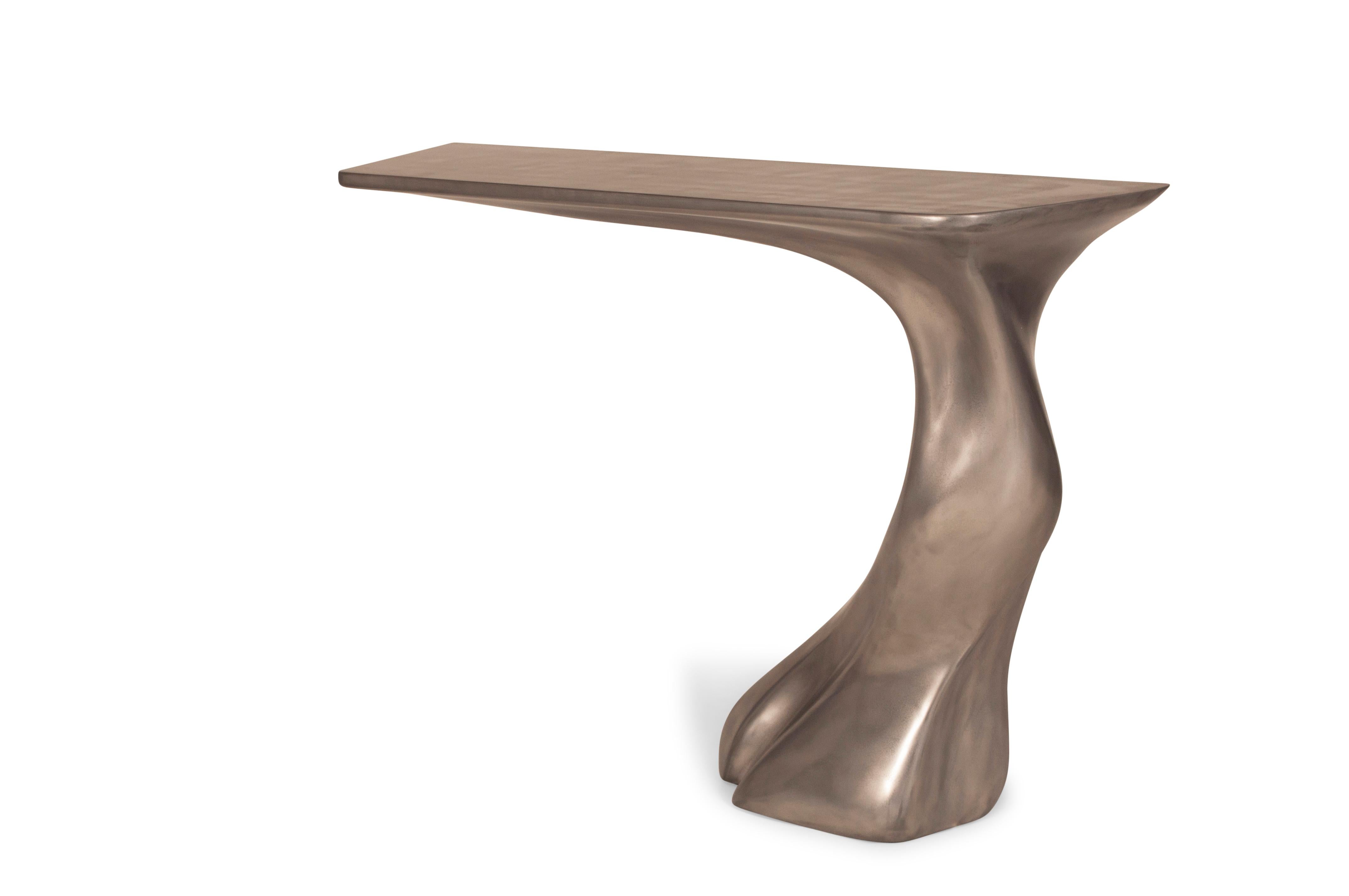 Frolic console table is a stylish futuristic sculptural art table with a dynamic form designed and manufactured by Amorph. Frolic console table is made out of wood with white matte lacquer finish. By the nature, the ashwood grain’s look would be
