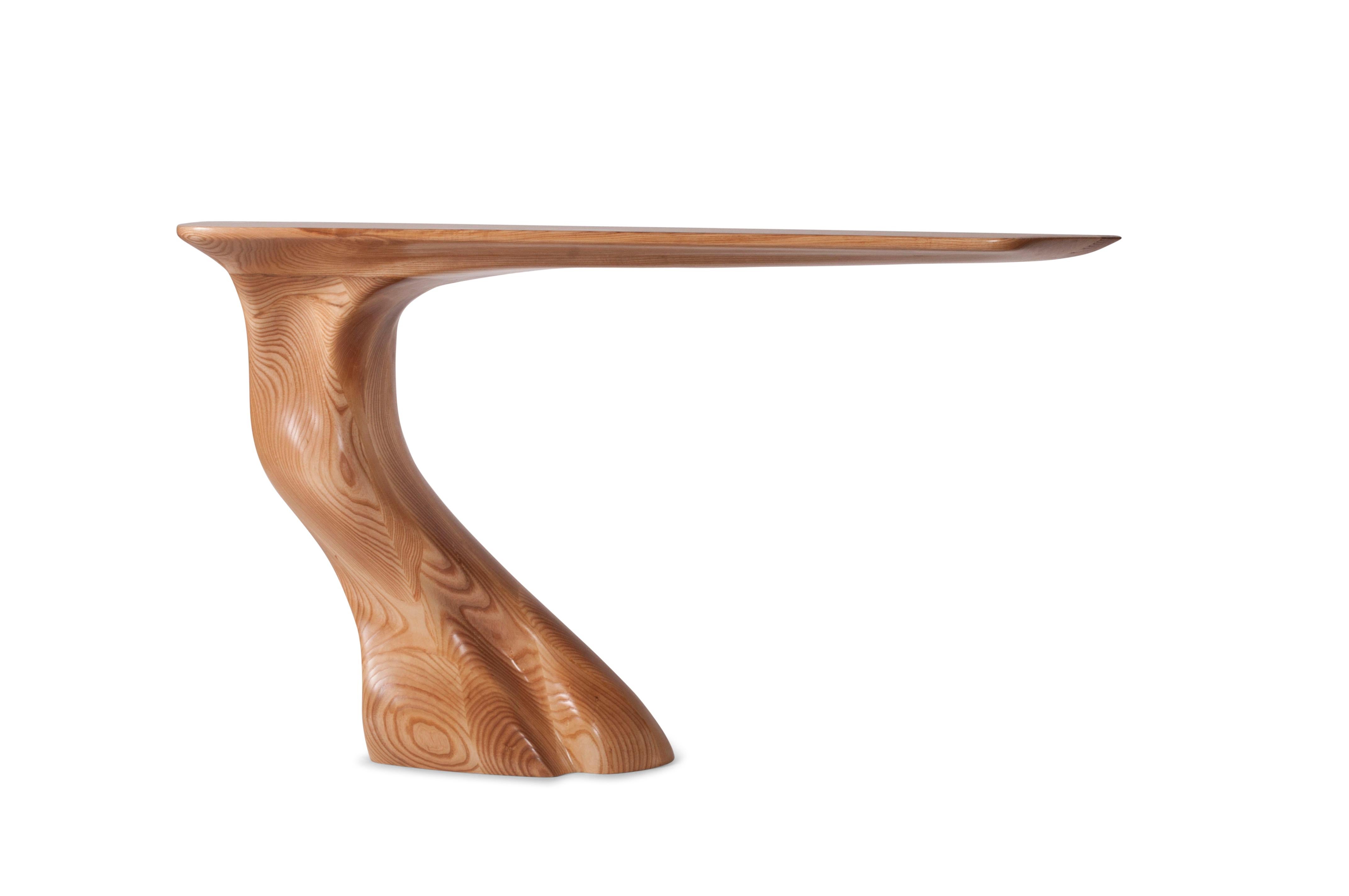 The Frolic console table is a one-of-a-kind piece that stands out with its unique shape and design. This wall-mounted console table features a cantilevered part that is supported by an adjustable bracket, adding to its modern and sleek look. What