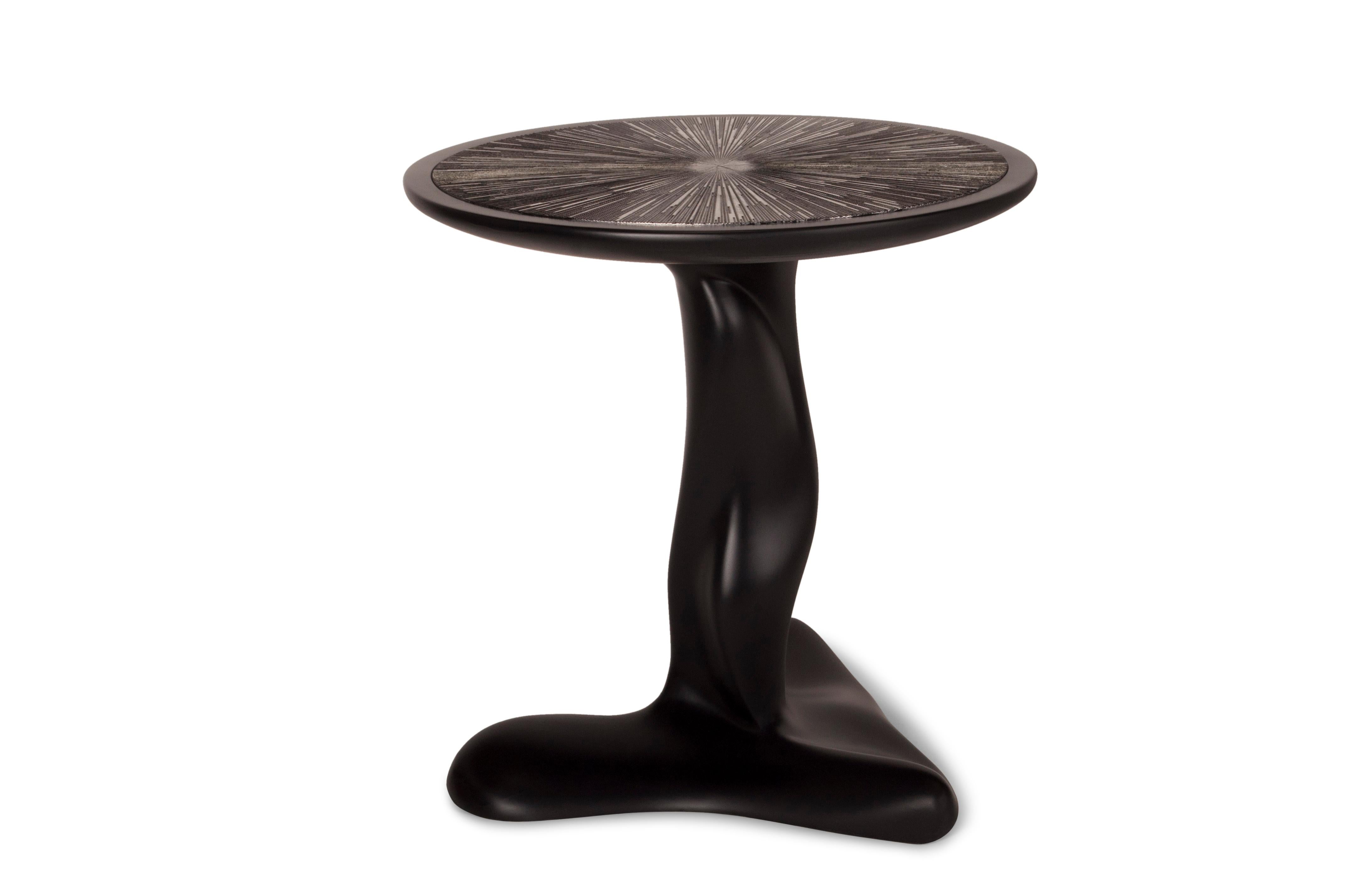 Helios side table is finished black matte lacquer. The top is lacquered black with silver leaves gilding. Custom finish and sized available.

About Amorph: 
Amorph is a design and manufacturing company based in Los Angeles, California. We take pride